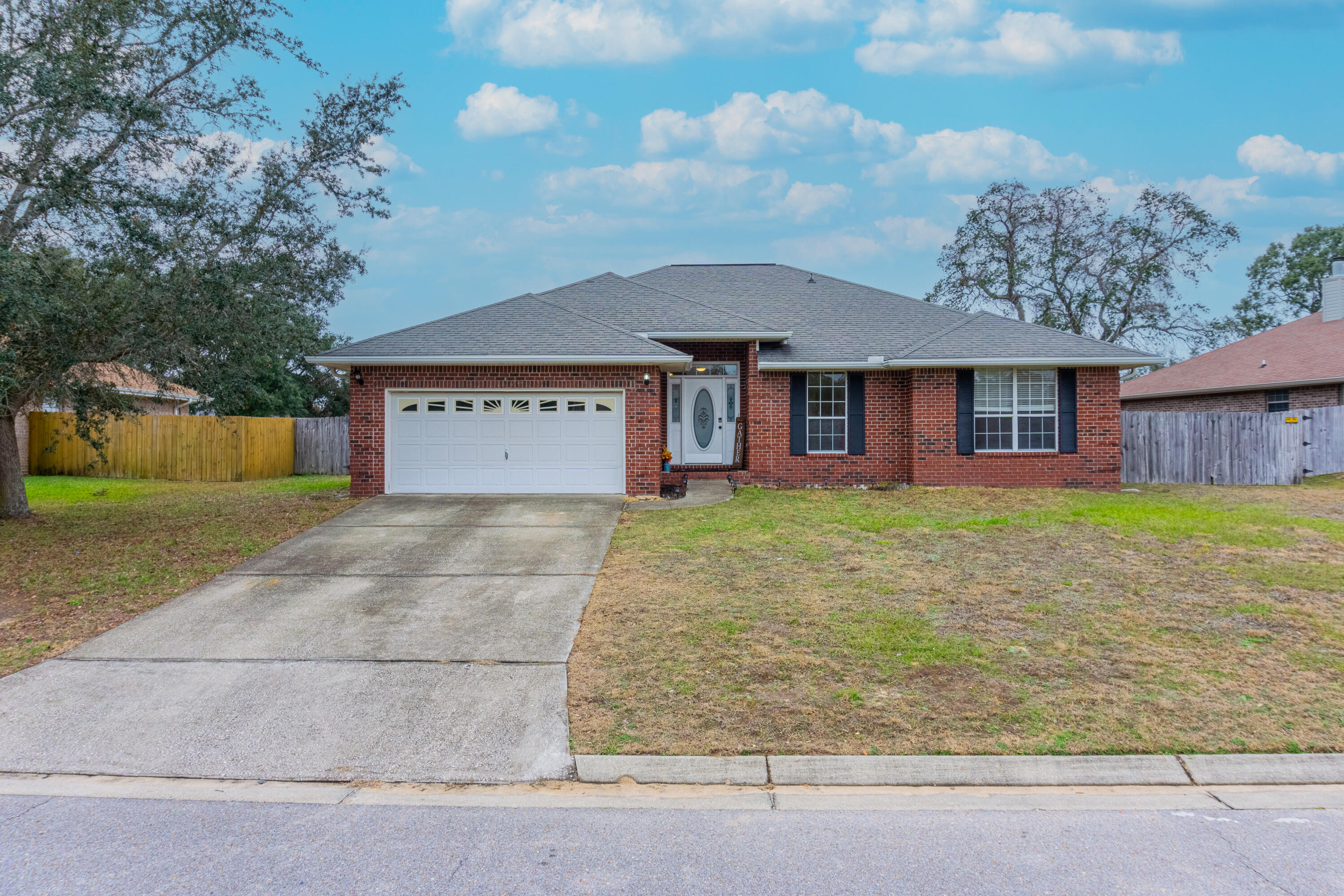 Tis the Season! New Year - New Home? Welcome to 2821 Shoni Dr, a spacious 4-bed, 2-bath all brick home in the heart of Navarre! Featuring luxury vinyl plank (LVP) & tile floors throughout, this home offers a huge Great room with vaulted ceilings, whilst the kitchen features granite countertops and newer LG appliances, perfect for cooking and entertaining. The master suite comes with a huge walk-in closet, Garden Tub and granite topped double vanity. Heading outside, you'll find a good size, flat, fully fenced back yard with a private well irrigation system. With a lick of paint to make it your own, this lowest priced home in the quiet, sought after neighborhood of Waterstone could be yours! Located near top-rated schools, bases and Navarre's stunning beaches, this property is a must-see!