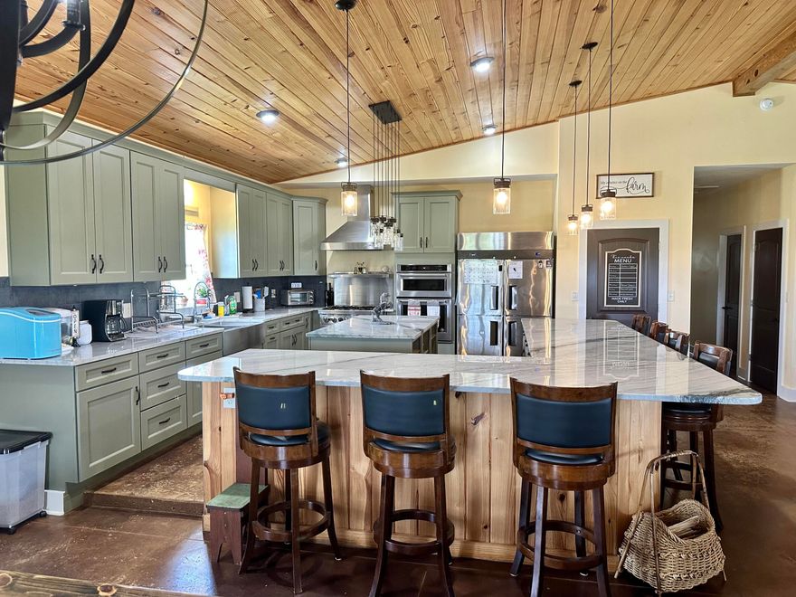 The possibilities are endless in this craftsman style custom farmhouse that offers a unique blend of distressed rural charm and contemporary flair while providing you with timeless character set amongst an impressive 10 acres. With its traditional focus on nature, you'll enjoy the many attributes that make this home a rarity including a sense of peacefulness, privacy, and enjoying room to expand. You'll find tranquility watching the Florida sunsets and soaking in the crisp air amid an extensive front porch flanked by ceiling fans and tapered columns overlooking the sprawling green lawn. From the moment of entry, you are captivated by an expansive open floorplan that has perfectly combined farmhouse chic with a simplistic approach with its maintenance free stained concrete flooring, peaked
