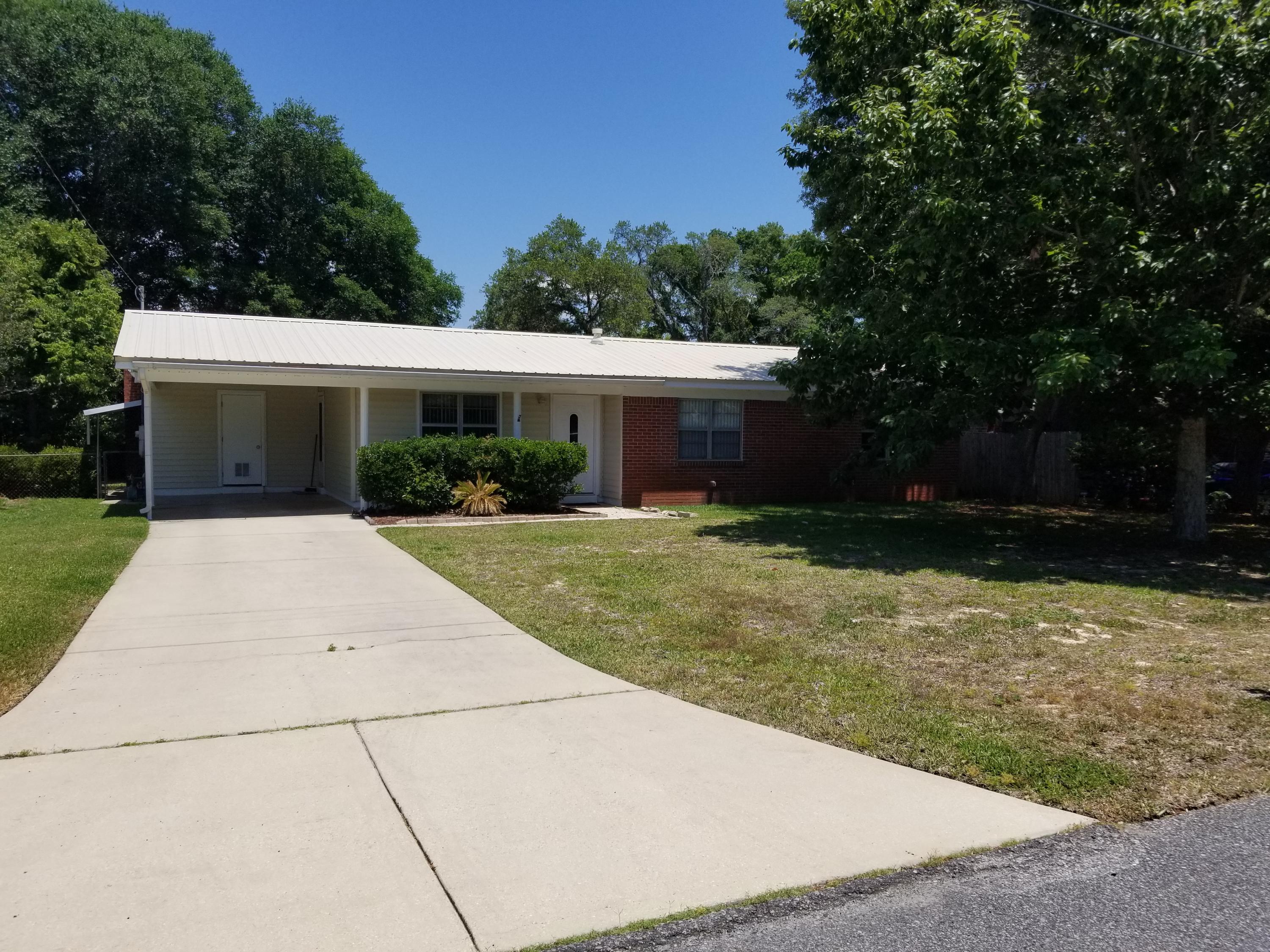 Welcome Home! This 3 bedroom 2 bath all brick home is a must see. Home has a great layout with a living area, large den with fireplace and a huge kitchen with an eat in area. Nice metal roof. AC was replaced in 2015. There is an entrance from the rear of the property and both metal buildings in the back yard convey. Sprinkler system runs off private well. Laundry room is under carport washer/dryer convey. Within walking distance to ball park and bay access. Don't miss it! Call today! Buyer to verify measurements and any other information deemed pertinent.