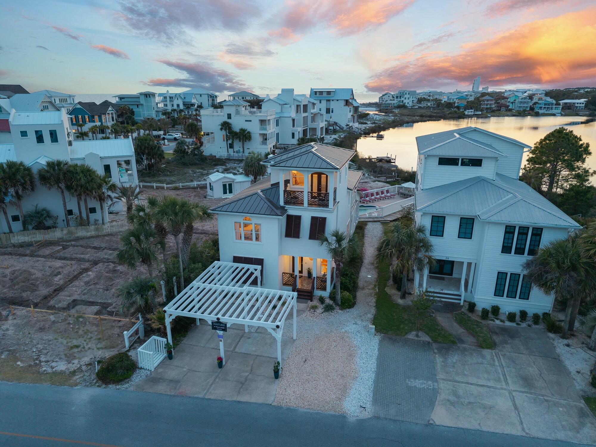 Have the best of both worlds on 30A to include a beach and lake house! Nestled just South of 30A, 'A Villa Lago' is a breathtaking retreat, poised just minutes from the areas renowned turquoise-hued waters and new urbanism communities. Upon initial entry, warm wood tones infuse the foyer with coastal ambience casting an inviting glow over the spacious interiors. The inviting great room with fireplace offers picturesque views of Eastern Lake while the screened in porch beckons for outdoor gatherings. Whether dining al fresco, relaxing by the pool, or enjoying a canoe or paddle board ride, this home offers the ultimate in idyllic coastal living. The gourmet kitchen features custom cabinetry, upgraded granite countertops and a stainless-steel appliance package. The spacious first-floor junior suite with adjacent full bath and laundry complete the first level. Perfectly positioned to take in the extraordinary views of the Eastern Lake outflow into the Gulf, the primary suite lives large offering a seating area and private terrace. The spa-line ensuite offers dual vanities, a soaking tub and walk-in shower. 2 additional junior suites with king size beds (one of which is equipped with private bath) are offered on the far east wing of the home. A bunk room and daybed are offered on the "Crow's Nest" with gorgeous views of Eastern Lake and the Gulf. Make an evening night-cap and step outside to the private covered terrace, the perfect place to admire the mesmerizing hues of the Emerald Coasts sunsets each and every night. The shared dock (with the adjacent homeowner) offers a canoe and kayak launch, seating area and boat lift making lake-living a breeze.

Nestled on the south side of Scenic Highway 30A, the sought-after area of Eastern Lake offers residents with close proximity to the Gulf and State Park, as well as a walking distance to Greenway Park, the "new town center," featuring Wild  Olives, Canopy Road Breakfast Cafe, Turbo Coffee, Local Cantina, Pecan Jacks, Jonah Allen Art Gallery, local boutiques, and State Forest access. With impressive annual revenue projections exceeding $125,000 and no HOA, 34 Beachside Drive is a compelling and rare opportunity for investors and second or full-time residents alike.  Recent notable upgrades to the residence including a newly installed roof in 2025, newer HVAC systems and Water Heaters, a recently painted exterior, and new furnishings. 

Schedule a private viewing today and start living the coastal lifestyle you deserve.