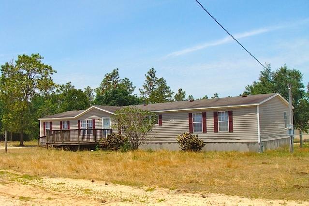 BRING YOUR HORSES & ALL ANIMALS! Here's a good deal on a 3BR 2BA mobile home and 5 cleared acres with a HUGE barn in NW Walton Co. This property is convenient to Crestview, Eglin AFB, Niceville, and DeFuniak Springs. The acreage has numerous shade trees and an older mobile home that needs some attention. Animal lovers will appreciate the HUGE 60' by 56' metal barn complete with many stalls, two big roll-up doors, water, electricity, and a 12' x 60' attached enclosed lean-to for hay and equipment storage. The mobile home needs some cosmetic work and all new floor coverings, but seems structurally sound, and is in otherwise pretty good condition. The decks on the front & back of the house are older and need some work. Due to condition of home, this probably needs to be a cash sale.