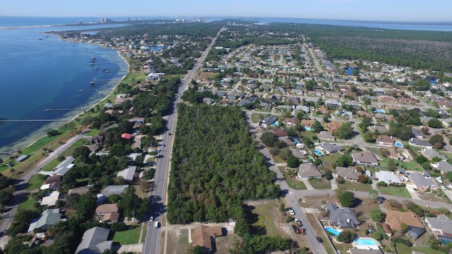 2.96 ACRES - VACANT PROPERTY IS ZONED COMMERCIAL AND HAS A MULTITUDE OF POSSIBILTIES FOR THE RIGHT ENTREPRENEUR. Fabulous corner location on the north side of Gulf Beach Highway next to the entrance to Chevalier Subdivision on Challenger Way. Located between Pensacola and Perdido Key on heavily traveled Gulf Beach Highway (CR292A) just 5 minutes from Sorrento Road and the Gulf Intracoastal Waterway in Perdido Key. High and dry. Lot measurements are estimated. Information is deemed reliable but not guaranteed.