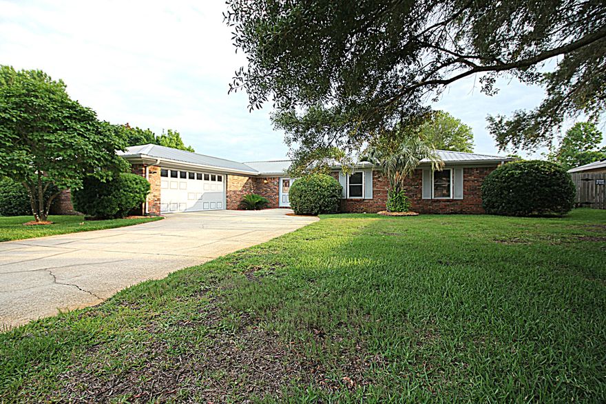 SELLER WILL PAY FOR BUYER'S HOME INSPECTION AND 1 YEAR HOME WARRANTY!!! This beautifully updated spacious home is located on a quiet street in Lake Lorraine. The home features updated flooring throughout with laminate wood flooring in all common areas and bedrooms. The kitchen has an abundance of refinished cabinets with all new hardware and corian counter-tops as well as a french door refrigerator that can be negotiated to convey. Both bathrooms have many updates and are very roomy. The master suite has a private remodeled bathroom with custom walk-in shower and double closets and you'll enjoy a private florida room off the master suite. Two living/family rooms offer plenty of space for a large family or for entertaining. The laundry room has a utility sink and newer hot water heater.