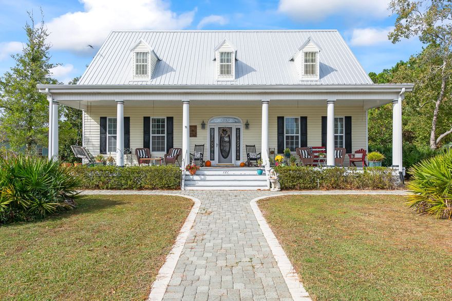 MOTIVATED SELLER! Classic and Captivating, this home harmonizes the Carolina's timeless charm with the alluring amenities of Florida's Emerald Coast. This southern cottage design, featured in Southern Living magazine, was created by William E. Poole Designs INC and was ''built to look as though it has always been there''. Extraordinary details have been conscientiously joined with exquisite craftsmanship in this custom 4 bedroom home including an upstairs studio and wet bar. Notable features include a sprawling front porch, custom arched entry way with adjoined built-in bookshelves, Australian Cypress hardwood flooring and handrails, 10 ft ceilings, fireplace, private dining room, 2 car garage, large backyard and outdoor shower. *New roof in 2019 and new dishwasher and farmhouse kitchen