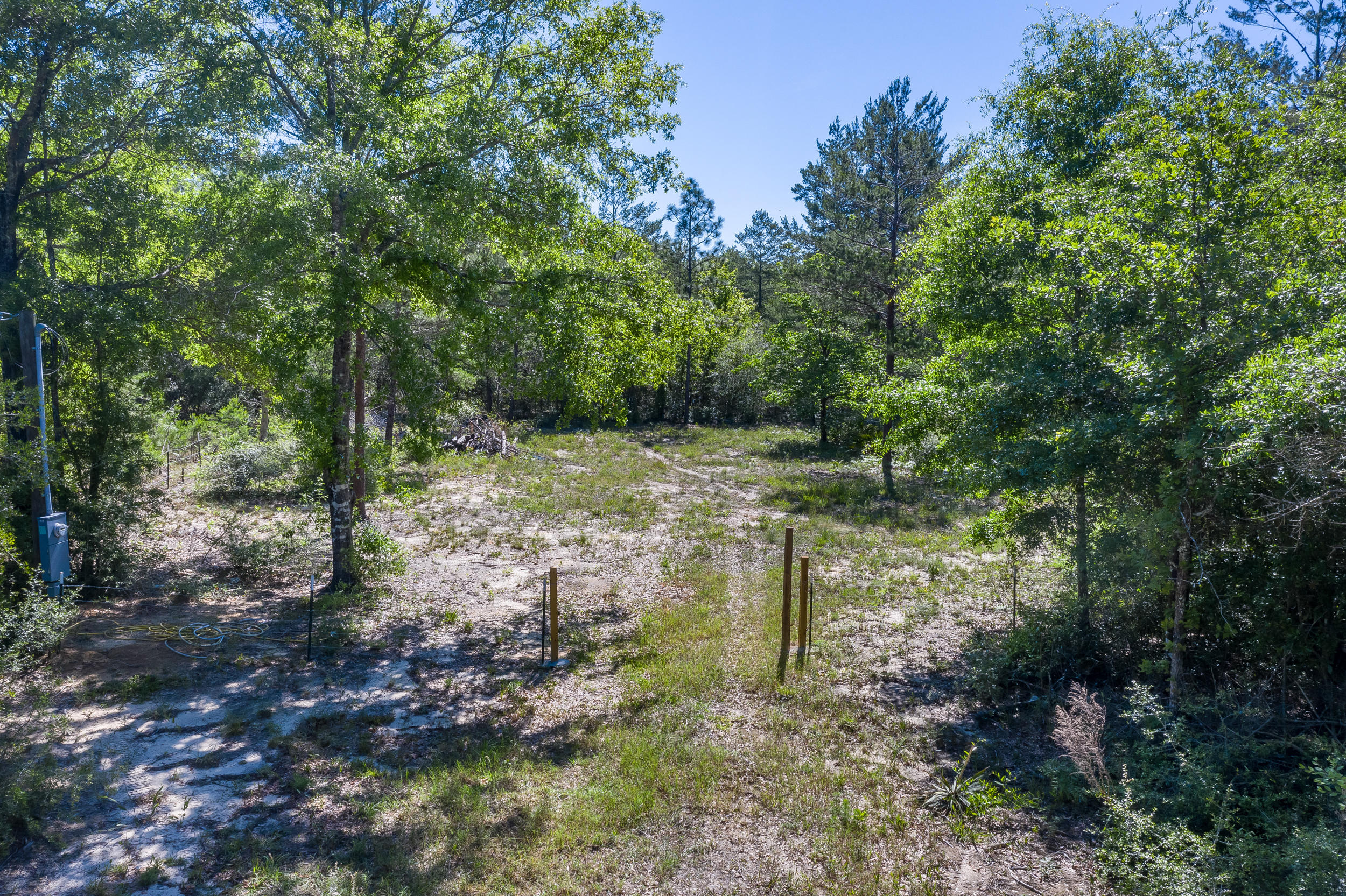 Nice level lot that has been cleared and fenced. Power pole and well have been installed.