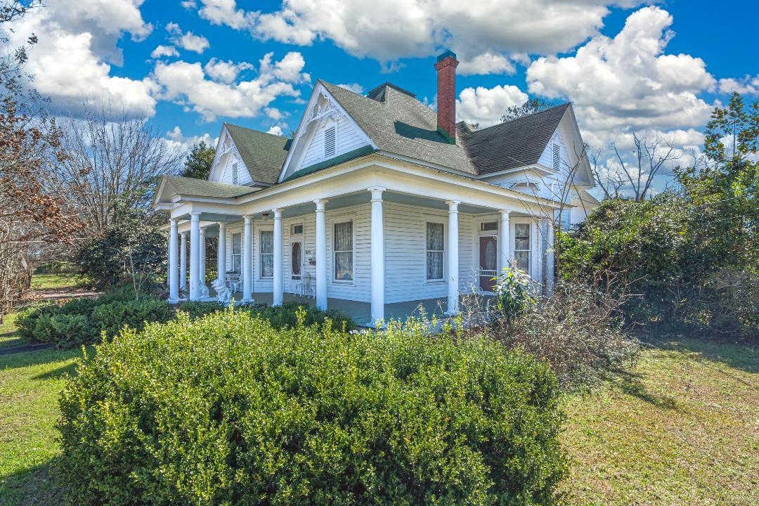 2 story Victorian Home in Florala, Al with so many original features (see photos). Includes heart pine and oak floors, formal living room and formal dining room, 2 bedrooms plus nursery/office downstairs and bedroom suite upstairs. 4 fireplaces (all coal style), 14 ft ceilings in most of downstairs - rest are 10 ft, original pocket doors, original french doors, original wainscoting, original transoms above doors, original window glass, wrap front porch (8.3x70) plus screened porch, 15 columns on front and side exterior. Swing and hot tub on back deck are included. Green house plus extra storage building. detached 2 car garage. Fenced backyard. Great price on historic home just into Alabama. Direct drive to the beaches along the Gulf Coast. Sold as-is.
