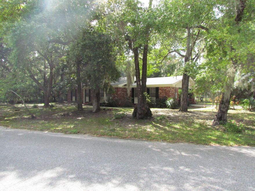 This is the one! Great home in Valparaiso with NEW ROOF and in ground POOL with liner that is one year old . Fantastic location close to schools and Eglin AFB and just down the street from Florida Park with playground and boat launch. This home lives large with separate entryway with closet and family room. Kitchen has lots of wood cabinets, breakfast bar and ample counter space. Appliances are black Kenmore and refrigerator stays with the house. There is a large dining room area with sliding doors leading to covered patio. Master bedroom has ''his and hers'' closets and master bath with original arabesque tile. Additional bedrooms are a good size. Home has been completely painted inside and out. Carport floor has a fresh coat of epoxy. Back yard is fenced and has a screened room ..perfect for summer nights..  The laundry room is separate from the house with entryway through the carport. Front yard has beautiful mature trees.  Home comes with a Home Warranty for new buyers peace of mind.