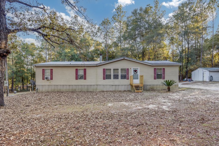 Check out this perfect starter home set up, located in the highly sought after Baker area! Resting on almost a full acre, including a metal work shop with power! Step into this charming 3 bedroom, 2 bathroom home, offering new vinyl flooring throughout and a open floor plan for all your entertaining needs! Very spacious kitchen with ample amounts of storage, beautiful light stained cabinetry! Also including a wood burning stove in the living room! Very large master bedroom, along with a double vanity sink and his and hers walk in closets! Good size spare bedrooms as well. To the back of the home you are greeted by a large covered back porch, following around to the large metal workshop! Come and see what all this home has to offer the new potential owners!!!