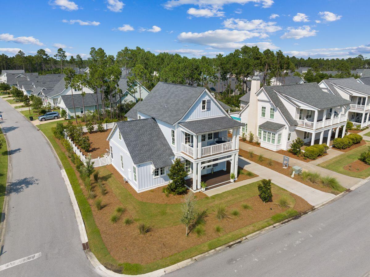 This beautifully designed home on a corner lot is perfect for full-time Florida living. It has four bedrooms, three-and-a-half baths and shady covered porches to the front and rear. The hub of this immaculate home is a bright and airy 27-ft. great room with a spacious dining area and open-plan kitchen. This generous living space connects with the outdoor porch, which overlooks a landscaped yard with space to add a private pool if desired. While the front porch offers the perfect place for cool drinks and intimate conversation, the rear covered porch and open deck are for coming together with family and friends. Ten-ft. ceilings and wire-brushed wood floors add to the high-quality interior culminating in the chef's kitchen with a family-sized island.