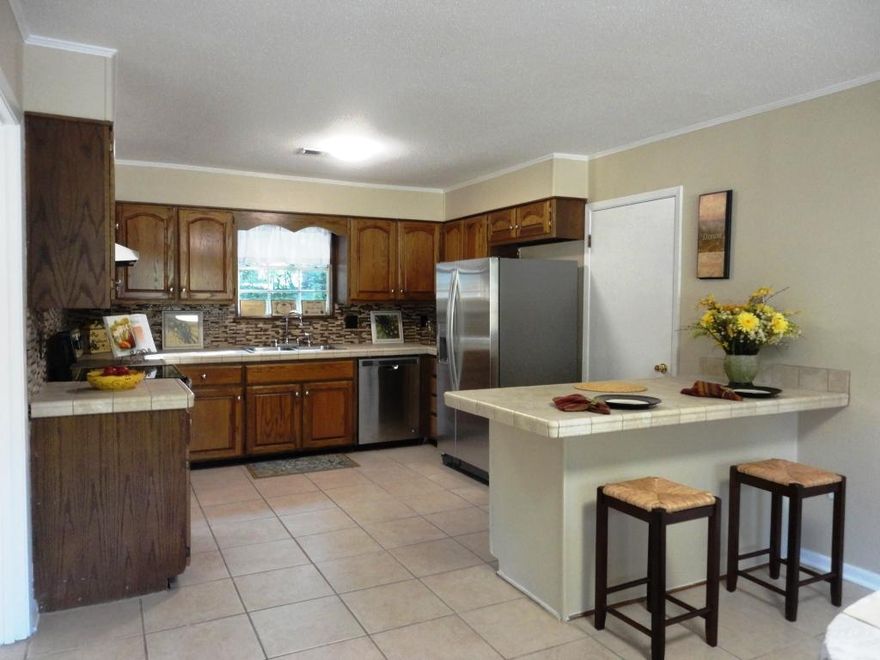 Welcome to this wonderful Niceville home. The seller has recently spent $35000 updating this home! Starting with the kitchen, you'll find new Whirlpool kitchen appliances, a new backsplash and new lighting. The eat in kitchen and adjoining living room create a lovely open floorplan. There is a breakfast nook with a large tiled counter. The living room has lots of natural light and overlooks the front yard. Tile floors flow through the kitchen, dining room, living room and hall. They are sturdy and can handle a lot of use and abuse with pets and family. Just mop and go.