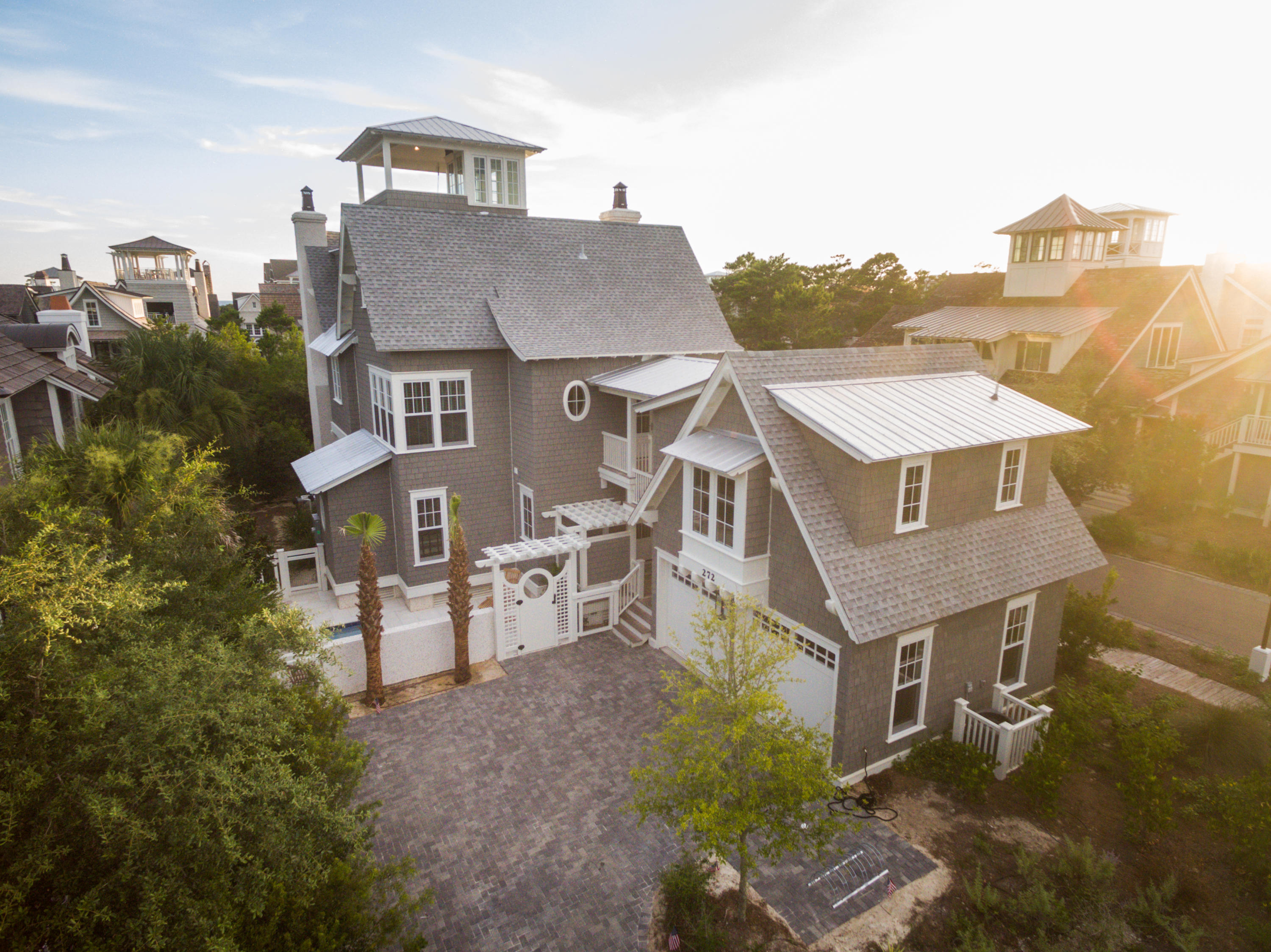 Introducing 272 Yacht Pond Lane, a home truly inspired by the grace and style of the tranquil surroundings. Rich in its construction and with unparalleled architectural finishes, this residence is located on a large corner lot, just steps from a pedestrian boardwalk leading to the most beautiful, private beach on 30A The moment you arrive, the attributes which make this home so special are immediately recognized. The first floor offers three uniquely designed guest bedrooms, one a master and each with their own, perfectly appointed en-suite baths as well as a large grilling porch with fireplace, pool and summer kitchen. Ascend the grand, three-story staircase to the second level where the expansiveness of the space will surely impress.