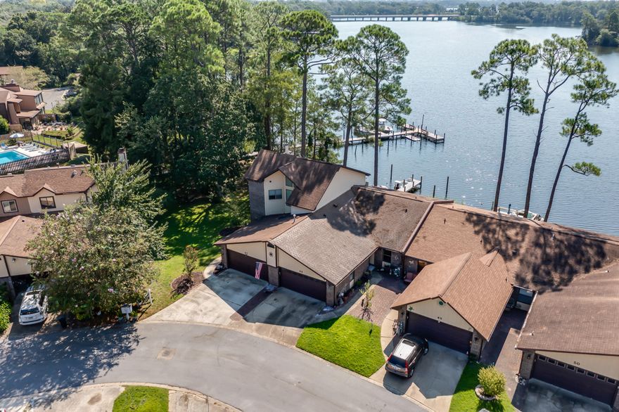WATERFRONT PARADISE! Beautiful waterfront home in Hidden Cove with private dock on Tom's Bayou! Enjoy boating, fishing, and stunning sunsets from this spacious four bedroom, three bathroom home with bonus room and large upstairs storage. Water views from nearly every room. The updated kitchen features granite countertops, gas stove, and new appliances. Main-level bedroom and bath offer added privacy, with an additional master upstairs. Relax in the screened-in porch overlooking your deck and dock. Tile and wood flooring, with newly carpeted stairs for safety, magic gas fireplace, and central cooling complete this peaceful waterfront retreat.
