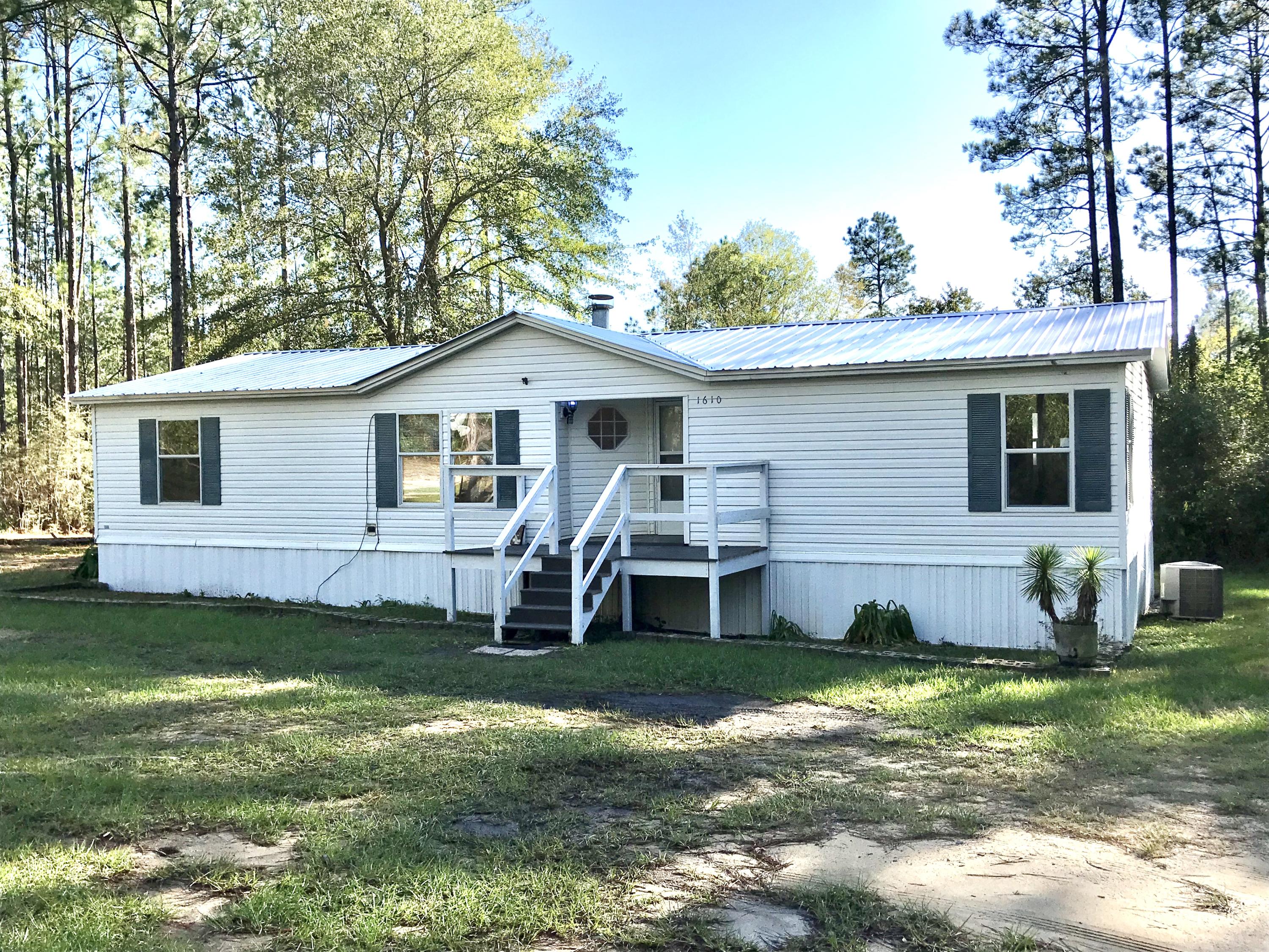 Very nice split floorplan 3/2 double wide mobile home situated on 4 acres off of Rock Hill Road halfway from DeFuniak Springs to Freeport. The home has a large master suite with a very nice master bath. There is a large workshop behind the home perfect for large projects or even a home based business. The home has a large living room with fireplace, a separate dining room and open kitchen. Water is provided by a private well. Plenty of parking out front and out back by the work shop. Just minutes from Freeport, you can enjoy all of he benefits of living near the beach while still enjoying quiet evenings away from the crowds!