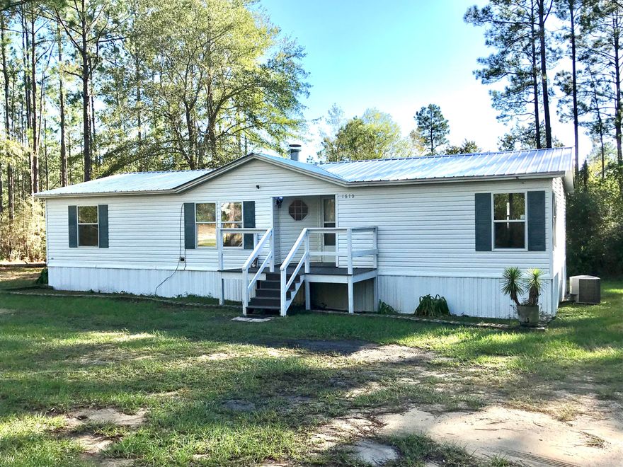 Very nice split floorplan 3/2 double wide mobile home situated on 4 acres off of Rock Hill Road halfway from DeFuniak Springs to Freeport.  The home has a large master suite with a  very nice master bath.  There is a large workshop behind the home perfect for large projects or even a home based business.  The home has a large living room with fireplace, a separate dining room and open kitchen.  Water is provided by a private well.  Plenty of parking out front and out back by the work shop.  Just minutes from Freeport, you can enjoy all of he benefits of living near the beach while still enjoying quiet evenings away from the crowds!