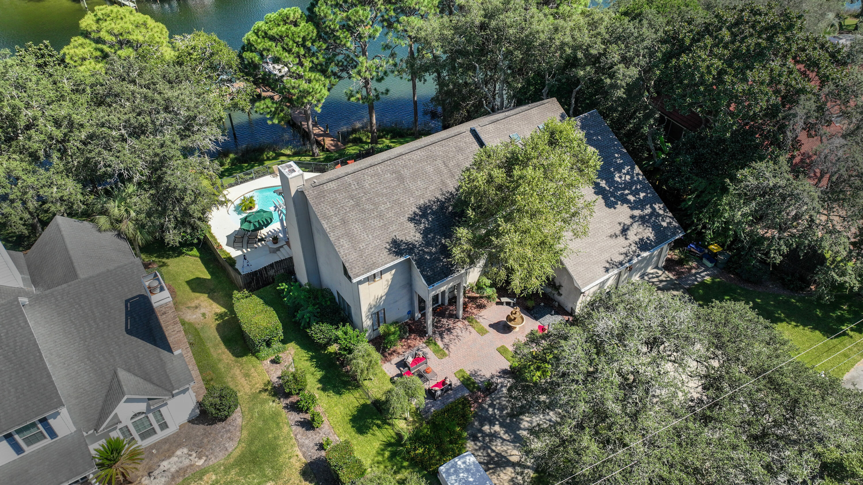 This gorgeous waterfront family home with a backyard oasis is located on Cinco Bayou in Fort Walton Beach. The exquisitely maintained home features an open floor plan with the spacious living area opening to the kitchen and breakfast dining area. A guest bedroom and bath and a laundry room are located on the first floor, as well as an office with custom built-ins. The master suite has a sitting area, fireplace, and private balcony. The second floor includes an open loft area, a bonus room, a bedroom suite, and another bedroom and hall bath. The two car garage allows for plenty of storage. The lush backyard includes a pool, beautifully manicured lawn, grilling area, and plenty of space to entertain. The dock has a boat lift and waterslide for ideal coastal living. Welcome to paradise!