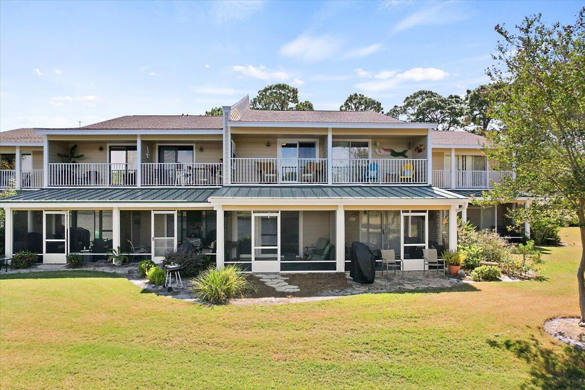 Enjoy the lake and bay views from the balcony or screened porch of this charming condo. Large open floor plan with two bedrooms on second floor.  Plenty of room for your beach supplies in the large outdoor storage room. Golf Cart included.