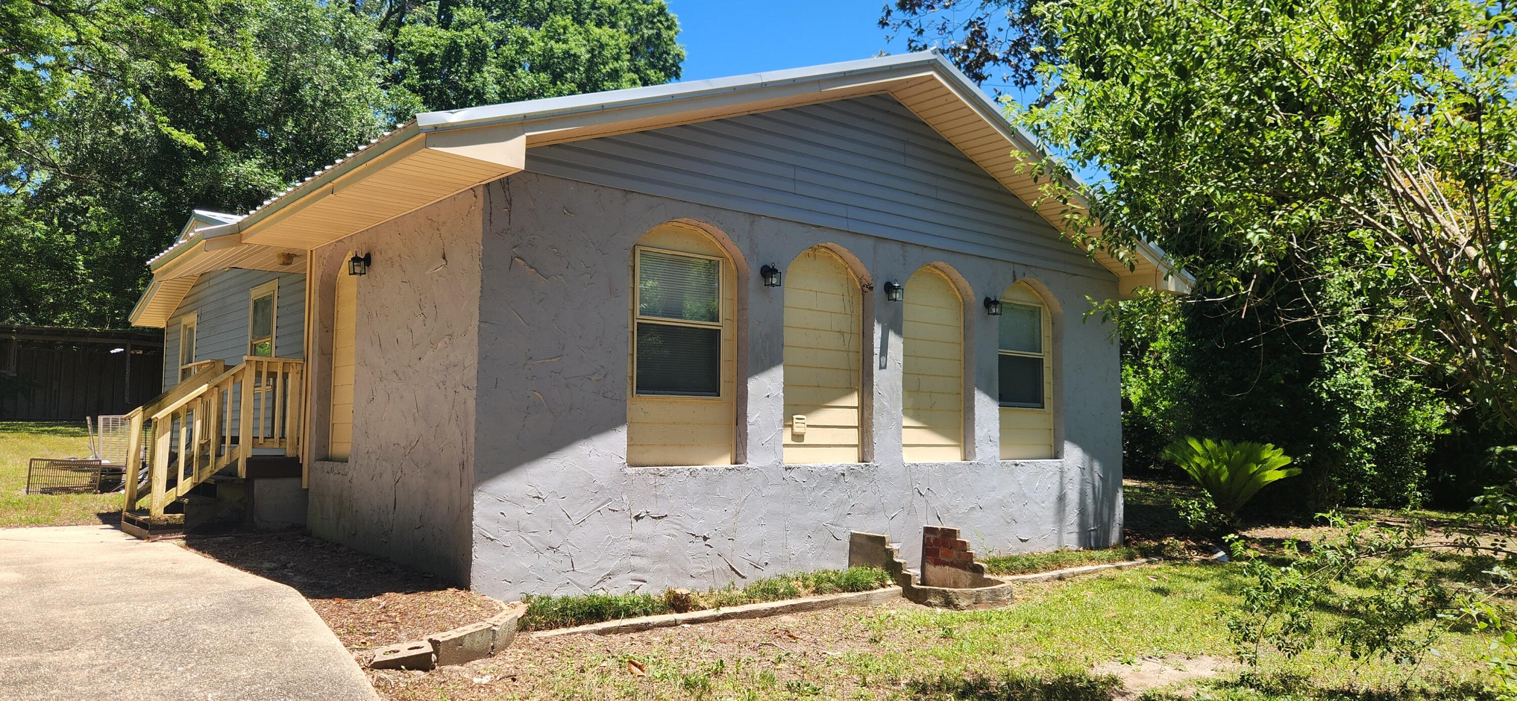 Investors special on this one. Home sitting on two lots, rent or live in the existing home and build or put another home on the other lot. Main home is three bedroom two full baths. Wood flooring through out home. Seller will be installing a new HVAC, water heater bathroom vanity and appliances in the home with an acceptable offer. Metal Roof installed 2017. Out side you'll find fruit trees galore including orange, tangerine, lemon and fig. There is also a workshop and gazebo, that needs a a little TLC but has potential. Come and see the potential this property has to offer.