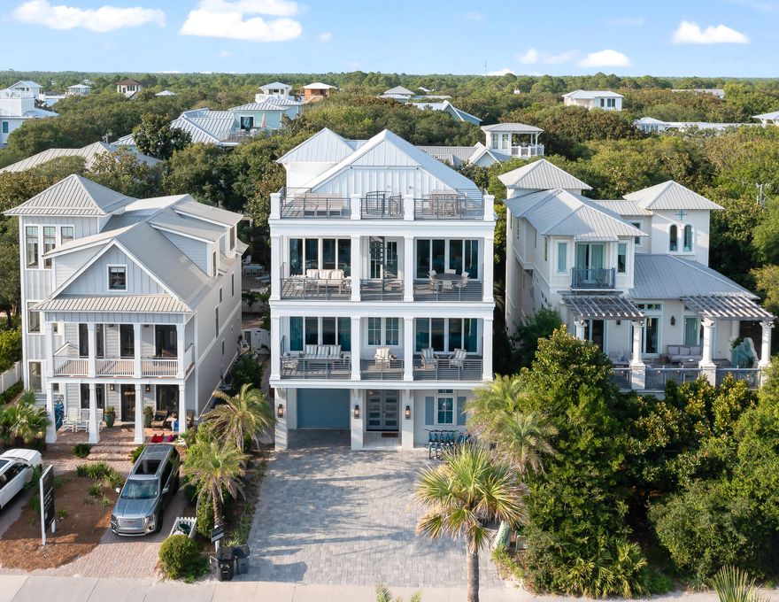 Welcome to this 6 bedroom, 7.5 bath 3 story beach vibing house located in Seagrove Beach! This property is directly on the north side of 30A and has public beach accesses on either side of it at Hickory Street and Live Oak St and is a short walk or bike ride to Seaside. The views of the emerald waters of the Gulf of Mexico are just breathtaking from the homes multiple balconies or the stunning rooftop deck! This property also offers a private an impressive outdoor patio including an outdoor kitchen, alfresco dining area,  and a heated saltwater pool with tropical landscape!  So enjoy the white sandy beaches or your own private backyard oasis! The first floor has a spacious living area, wet bar and bunk room with ensuite bath and a conveniently located laundry room for all those beach and pool towels! Take the elevator or stairs up to the second floor which offers 3 guest bedrooms all with their own ensuites. Two of these bedrooms offer king beds and third offers 2 queen beds! The owner's retreat is also located on the second floor and offers its own walk-in closet, private bath with shower, dual vanity, a soaker tub that offers gulf views and access to the balcony that overlooks 30A and has view of the Gulf of Mexico!! A second laundry area is located on the second floor as well! The 3rd floor offer the main living space with the kitchen, dining area and great room and boasts an open floor with an abundance of windows and 3 sets of patio doors that open to the large balcony allowing for amazing views of the Gulf of Mexico and allowing the space to be filled with natural sunlight. This reverse floor plans allows you to take the most advantage of the amazing views of the coastline! The space has a wet bar with an ice machine and beverage refrigerator. A large kitchen island, wolf appliances including a double gas range, exhaust hood, dual dishwashers and convection oven along with access to a balcony on the back side of the home complete the kitchen area. There is also an additional bedroom with King bed on the 3rd floor with ensuite bath. A half bath completes the floor. Take the spiral staircase off the 3rd floor balcony up to the rooftop deck!! The perfect place to enjoy a great sunset or early morning sunrise! This home has been professionally decorated and is being offered fully furnished (less a few pieces of art). Interior features include hand screen-printed wallpaper, custom tile in all bathrooms and designer light fixtures throughout. The property does also have a one car garage and is being sold with the GEM (electric car) car. No HOA! This property is an ideal investment property or vacation property!! Call to schedule a showing!!    
