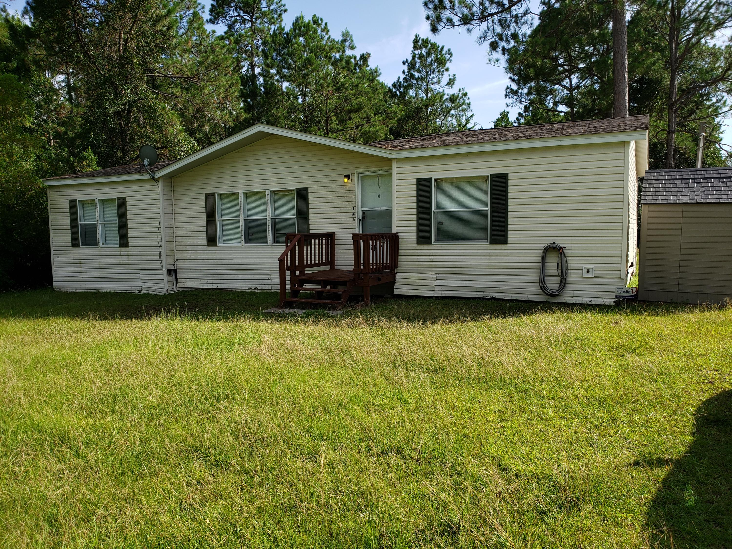 Great opportunity to own this 3/2 Manufactured home on 1/2 acre corner lot. Just 1/2 mile to Outpost Landing for great fishing and relaxing. Split bedroom floor plan. Nice open kitchen/living/dining area. Lots of counter/cabinet space. Outside the laundry room and through the doggy door is a nice little fenced area for your furry friend. This home is being sold fully furnished and the owners are even leaving a riding lawn mower. Just move in! This home will not last long!!