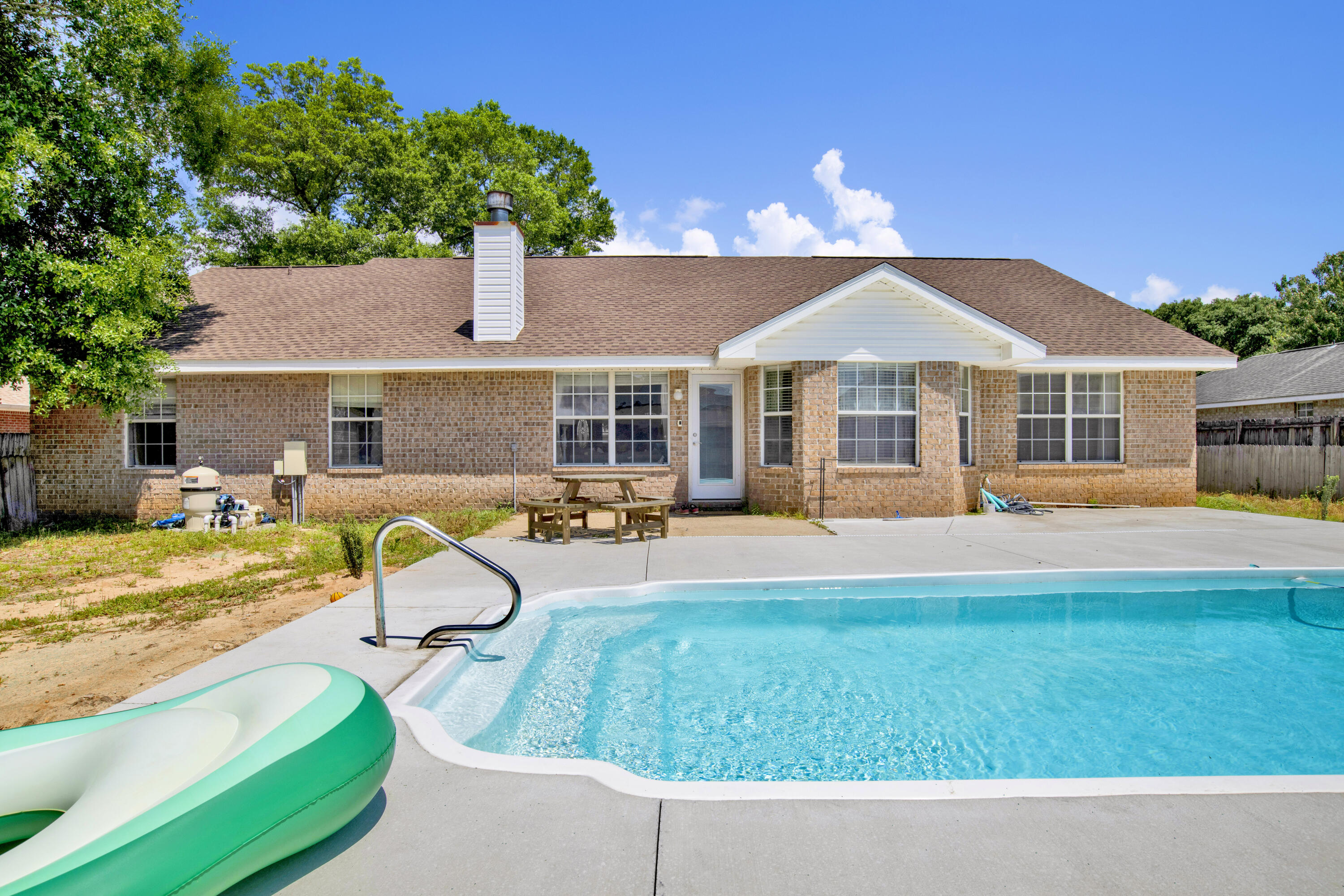 Welcome to your dream pool home! This 4 bedroom, 2 bathroom residence offers room for the whole family and is packed with features designed for comfort, functionality, and entertaining. Step inside to an inviting floor plan with luxury vinyl plank flooring in the main living areas and cozy carpet in the bedrooms. A versatile flex room provides endless possibilities--use it as a home office, playroom, or an additional living space to suit your needs.The heart of the home is the expansive living room featuring cathedral ceilings, charming plant ledges, and a cozy wood-burning fireplace. The updated kitchen is a chef's delight with butcher block countertops, stainless steel appliances--including a double oven--and a breakfast nook that overlooks the sparkling in-ground saltwater pool through bay windows. 
Host holiday meals or dinner parties in the elegant formal dining room, while the split bedroom layout ensures privacy. The spacious primary suite is a true retreat, boasting a beautifully updated ensuite bathroom complete with two walk-in closets, a garden tub, and a private water closet. Three additional bedrooms offer ample space, ceiling fans, and generous closet storage.

A large laundry room provides direct access to the double car garage, adding to the home's everyday convenience. Step outside to your fully fenced backyard oasisperfect for outdoor entertaining, complete with a refreshing saltwater pool to cool off on hot summer days.

Don't miss your chance to own this thoughtfully designed home that combines comfort, charm, and functionality in one perfect package!
