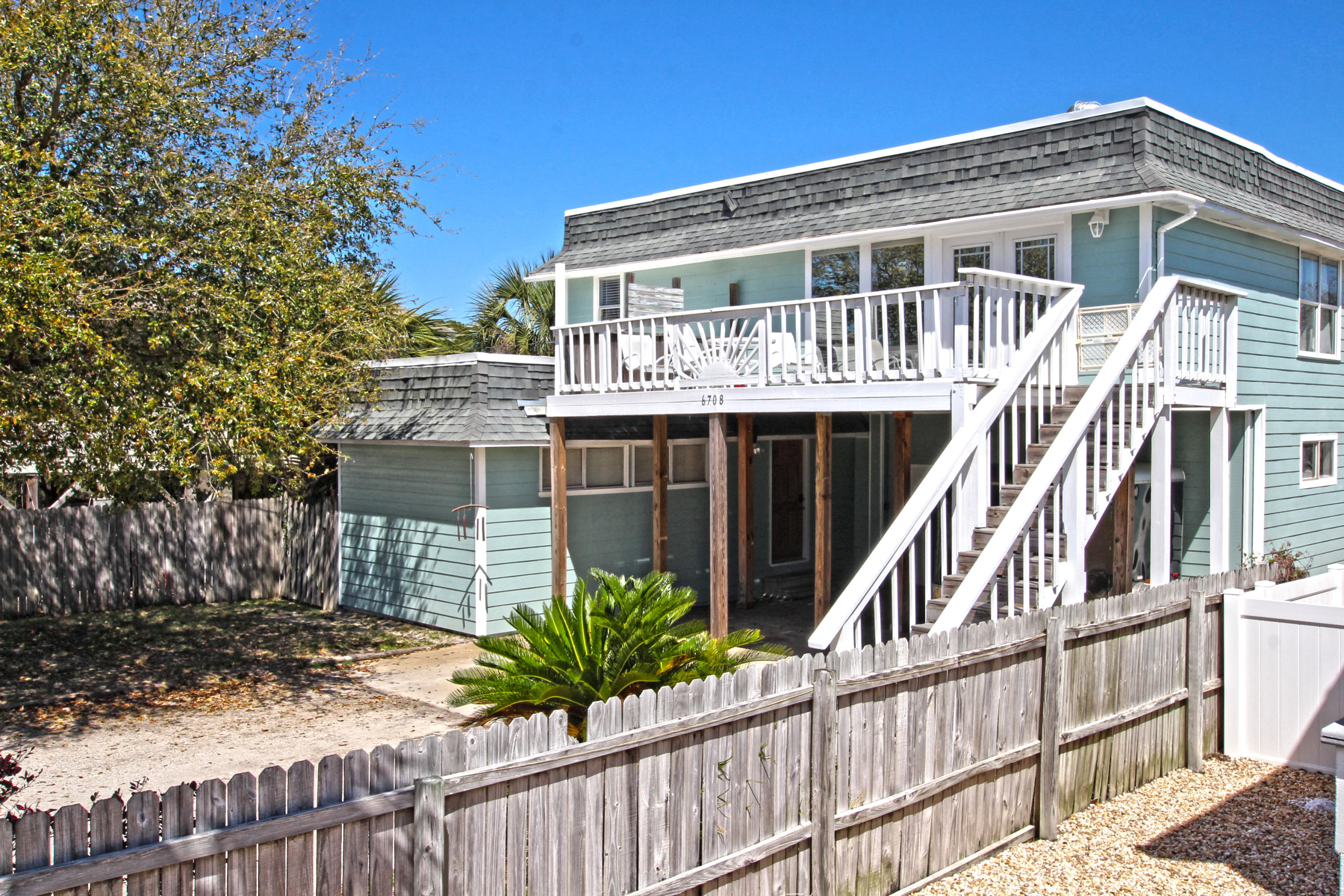 BEACH LIFE BEACH HOUSE. This renovated 3 bedroom 2 bathroom home is walking distance to the beach and has been beautifully redone. This one of a kind floor plan has an open living/kitchen area and a great master bedroom upstairs. You will love the media/sitting room in the master bedroom with a ''going to the movies'' style projection TV! Hidden in the lovely kitchen is a spiral staircase leading to the additional bedrooms and guest bathroom downstairs. The guys will love the massive workshop or ''man cave'' and the kids will love the large fenced backyard. This home has something for everyone! This home also has a security system installed. The roof is newer (replaced in 2013)and it now has hardie board siding(installed in 2010).