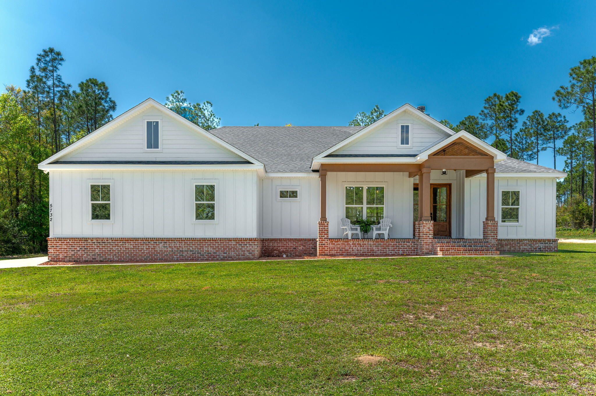 PRICE IMPROVEMENT!! Imagine your dream home in the country where this stunning modern farmhouse style home is located and situated on 3 acres. Inside you'll find a spacious open floor plan with cozy wood burning fireplace in the living room. The kitchen is equipped with a large center island, stunning granite countertops, stainless steel appliances, and an impressive pantry...there is both a dining area and breakfast area in addition to the bar seating, perfect for entertaining. The expansive master suite boasts a dual vanity, large tiled shower, garden tub, and walk-in closet with the clever design of leading into the laundry room. The split bedroom design offers additional generously sized bedrooms. The property features both covered front and rear porches. The beautiful wooded lot in the rear remains natural having been mulched with underbrush cleared out creating a nice setting featuring a scattering of trees and trails. The property backs up to Gum Creek Lodge. The buyer is responsible for verifying all areas of importance, including but not limited to room dimensions, lot size, zoning, etc...