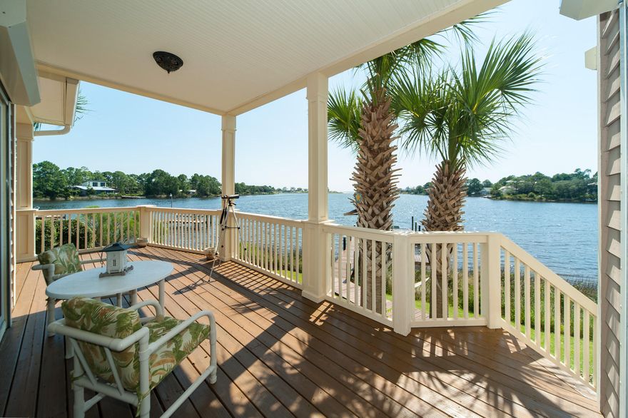 Meticulously designed by its only owner, this spectacular custom-built home offers the best of both worlds: lake and gulf living. Upon entry, discover expansive water views of Eastern Lake, the Gulf of Mexico, and your very own dock. The large rear porch is perfect for entertaining, or simply relaxing and taking in scenery. Easily launch your boat, kayak, or paddle board from your dock and take it all the way to the beach. The spacious open floor plan of the main level includes two guest suites with full bathrooms on opposite sides, providing privacy and comfort. The large kitchen, breakfast nook, and living area, complete with water views, flow as one room, which makes it ideal for large gatherings.