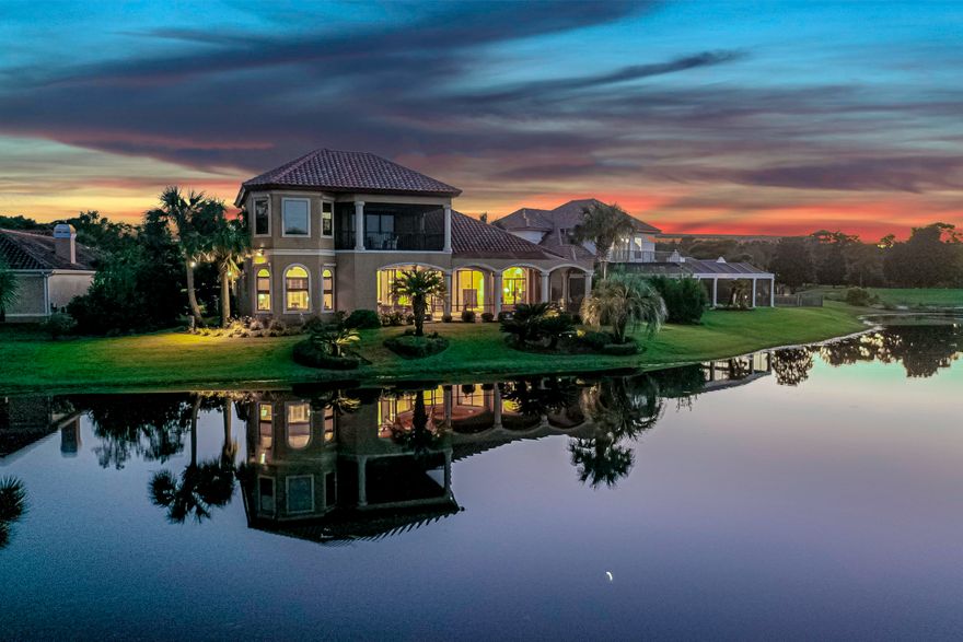 Stunning Mediterranean home ideally situated on one of Regatta Bay's premiere lots. Enjoy overlooking the lake and golf course while lounging in the oversized lanai complete with an outdoor kitchen and fireplace, as well as a heated pool with fountain. Exterior landscaping is ripe with lush tropical vegetation surrounding the property providing privacy without obstructing views. This is year-round Florida living. Downstairs has 3 bedroom and 3 baths including the master. Upstairs are two additional bedrooms with en suite baths that lead out to a large covered wrap around porch to catch the astonishing vistas.