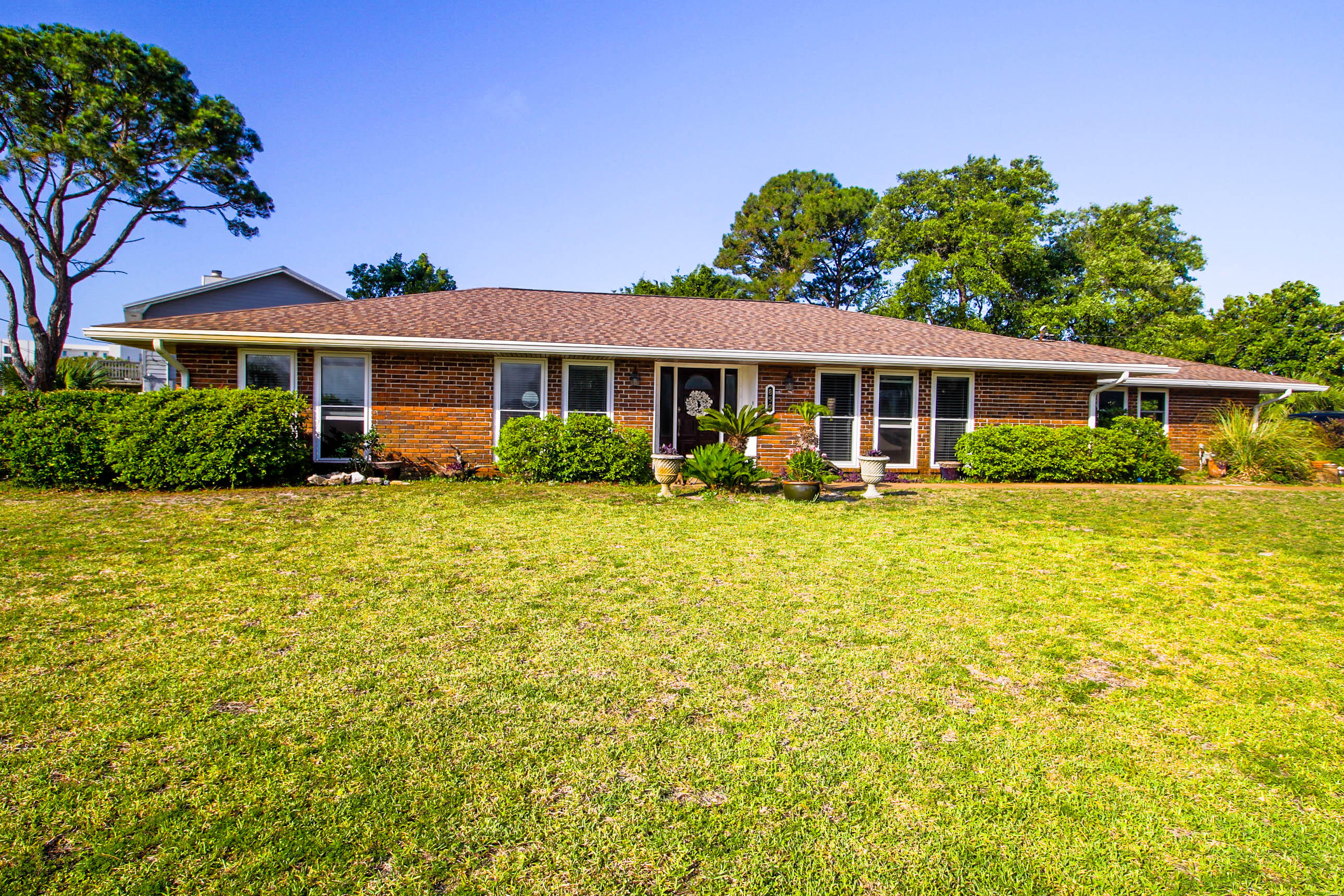 Just a short walk to the beach, this is not just a wonderful home, it's a lifestyle. Tucked away towards the West end of the island, this home is located in a quiet residential neighborhood convenient to restaurants and shopping. Featuring three bedrooms and two bathrooms, you will have plenty of space to entertain guests. Enjoy views of the intercoastal waterway from your large windows along the front of the home. This home offers beautiful hardwood and tile floors, crown molding, beautiful custom cabinets with granite countertop and custom back splashes. Home is all brick with steel construction. Side entry garage with a large driveway for extra parking. Large backyard perfect for relaxing and enjoying the breeze off the Gulf. Call today to own your perfect slice of paradise! All information is deemed accurate. Interest parties should verify all data, details, and information that is important to them. Fridge and Washer/Dryer will be sold in AS-IS condition. See documents for list of items that owner will sell with the home.