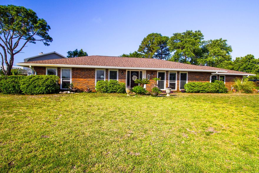 Just a short walk to the beach, this is not just a wonderful home, it's a lifestyle.  Tucked away towards the West end of the island, this home is located in a quiet residential neighborhood convenient to restaurants and shopping. Featuring three bedrooms and two bathrooms, you will have plenty of space to entertain guests. Enjoy views of the intercoastal waterway from your large windows along the front of the home. This home offers beautiful hardwood and tile floors, crown molding, beautiful custom cabinets with granite countertop and custom back splashes. Home is all brick with steel construction. Side entry garage with a large driveway for extra parking. Large backyard perfect for relaxing and enjoying the breeze off the Gulf. Call today to own your perfect slice of paradise! All information is deemed accurate. Interest parties should verify all data, details, and information that is important to them. Fridge and Washer/Dryer will be sold in AS-IS condition. See documents for list of items that owner will sell with the home.