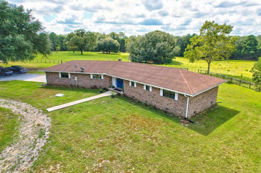 39 Acres of farmland to make your own! There are 5 cross-fenced, cleared, pastures (all with their own water source!), a turn out pen, and approx.17 acres of wooded land.  There are horse trails within the woods.  Horses were previously boarded on the property. There is a 4 stall barn with tack room.  The tack room has fresh paint, kitchenette, and full bathroom.  There is a 40' x 60' metal workshop, with electricity and water, to store all your outdoor toys and still have room for all your hobbies!  There is one exterior door, roll up garage door, and ½ bath inside the shop. There are 2 FULL RV hookups (one on each side of the shop); complete with electricity (one 30 amp the other 50 amp), sewer, and water. The house on the property has a beautiful open floor plan, with fresh paint, all new matching fans, LVP flooring and LED lighting throughout. The kitchen has newer shaker style two tone cabinets, granite counters, breakfast bar, exterior hood vent, new refrigerator, and new stove/oven. The master bedroom has two large separate closets and a sitting area.  All bathrooms have new vanities and toilets. There is a basement that has been finished off and can be used as an additional bedroom or a bonus/flex room. The attached garage is an oversized two car garage.   Out the back door is screened in porch (that was recently reframed and rescreened) and a 40' x 20' deck overlooking the expansive pastures, with mature trees (crepe myrtles, live oaks, black walnut trees, and pecan trees). A new orchard was planted in the  front pasture which features 2 peach trees, 1 pear tree, 2 plum trees, 8 apple trees, and 1 orange tree. HVAC 2018/2015, HWH 2021, Roof 2011