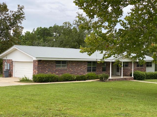 $5000. credit to buyers closing costs! 2 large lots 371 feet of gorgeous lakefront come w/this newly updated home. Almost 2 Acres! A long winding asphalt driveway showcases the landscaped yard w/camellias and pecan trees. The exterior features inc: metal roof, brick, covered front porch, a large storage/workroom w/concrete floor, Generac full home generator, propane tank and a back patio. The freshly painted interior features inc: new wood grain laminate flooring in the living areas and new carpet in bdrs. This home has special Handicap features throughout. The front living room opens up to the dining room which overlooks the kitchen. The kitchen has new countertops, appliances, and a large adjoining pantry/ laundry room that leads out to the oversize 2 car garage w/overhead storage.