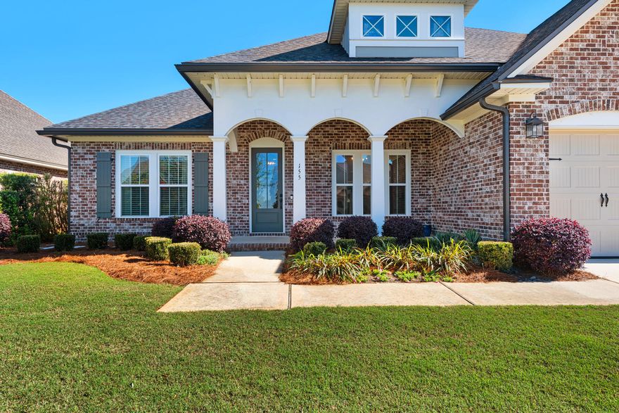 This classic craftsman-style home by Randy Wise is the epitome of luxury living with a large open-concept living space, four beds and three beautiful bathrooms. From the curb, it's love at first sight as you take in the colonnaded porch, cheeky dormer window and two-car garage beneath a gable roof. Step inside the home and prepare to be wowed by the spacious open floor plan and multiple windows. The magnificent chef's kitchen is tucked to one side behind a huge island topped with polished granite. It's designed for entertaining in style with Professional Series stainless appliances including a built-in refrigerator next to the walk-in pantry. The dining area is perfect for entertaining beneath the elegant chandelier lighting. Rich hardwood flooring in the living area and kitchen gives way