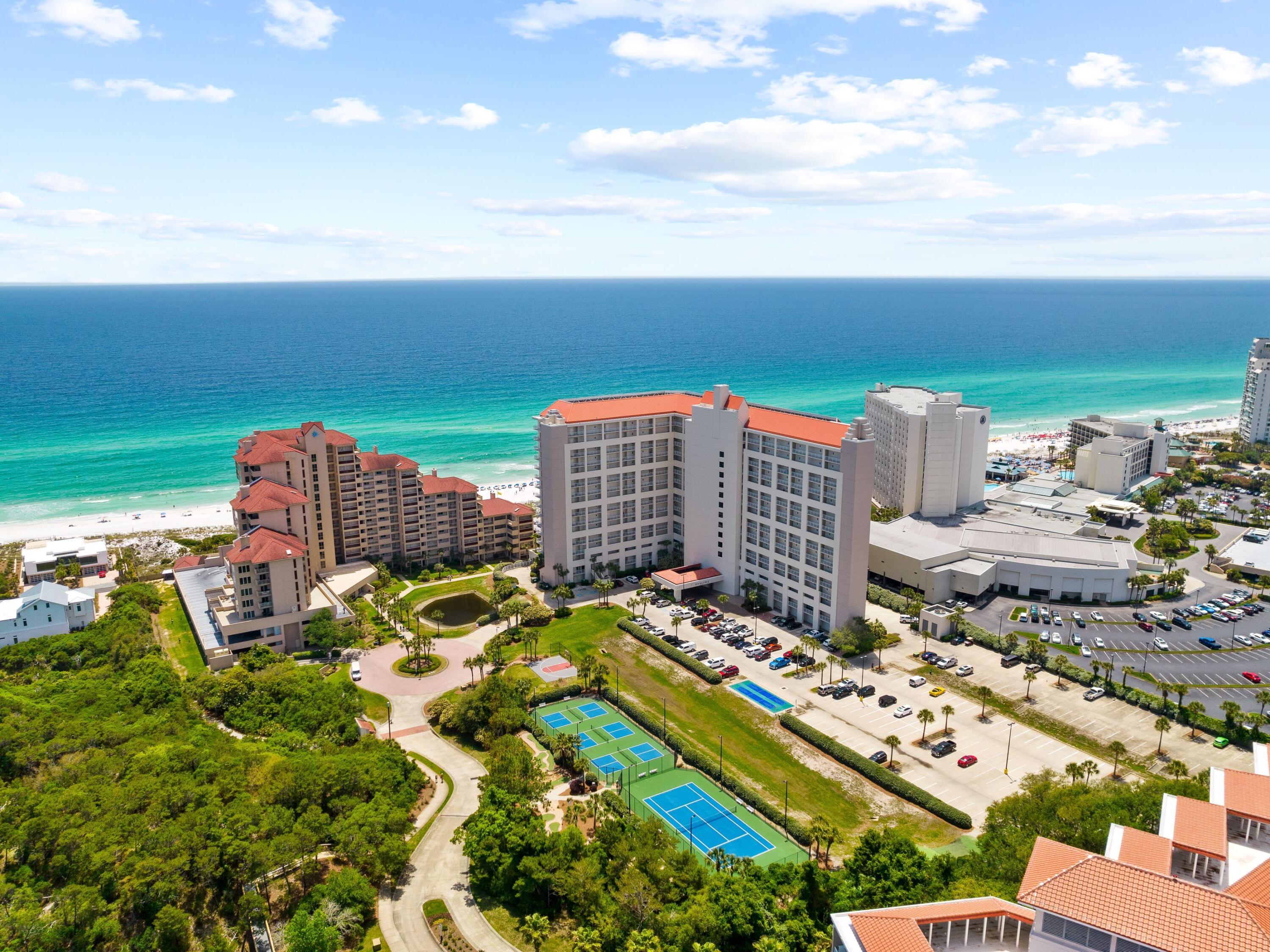 Situated behind the gated entry of TOPS'L Beach and Racquet Resort, this freshly updated two bedroom condo offers unparalleled lifestyle opportunities and endless vistas of the crystalline gulf waters below. An expansive and open floor plan offering a mix of easy to maintain tile flooring and plush carpeting in the living and bedroom spaces, this coastal oasis offers on site dining, multiple community pools with sunning decks and a resort fitness center, ideal for those looking to live their best life at the beach. An open kitchen layout offers new granite countertops and crisp stainless appliances, while the gulf front master gifts vast views and access to the large waterfront balcony.