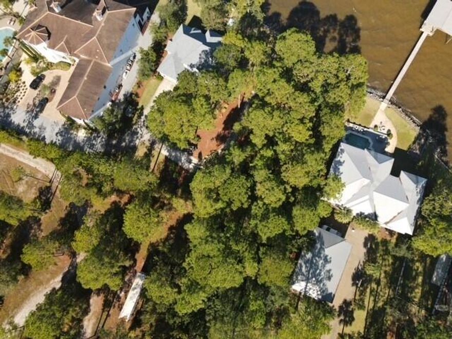 Beautiful waterfront lot with 100% uplands on Choctawhatchee Bay with an estate style setting. The lot has 77' of waterfrontage with an average depth of approximately 300'. The depth of the lot allows for a large building footprint with the potential for a detached carriage house or garage. The lot has good elevation and is located in the Bay Pine Shores SD with multiple new houses built.