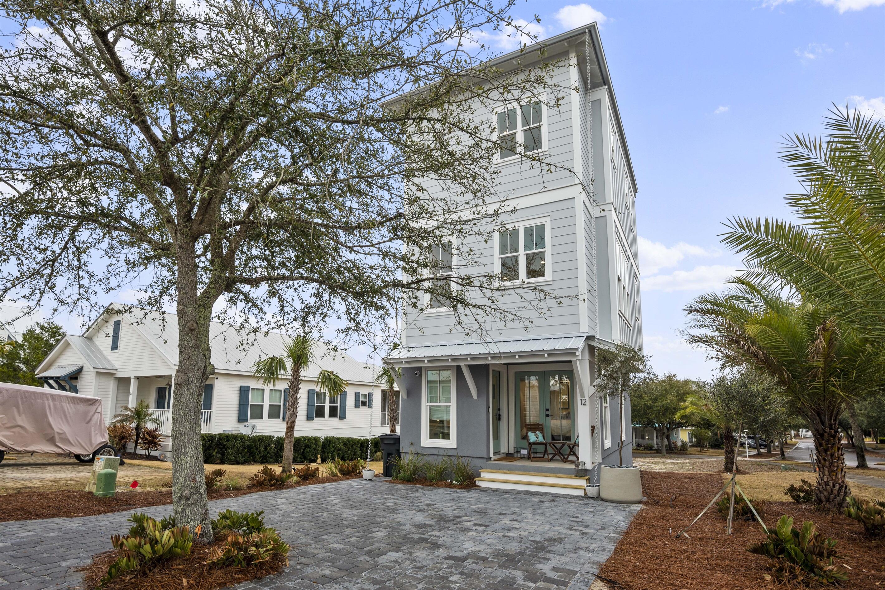 Incredible opportunity to own this exceptional upscale beach cottage within the charming gated community of The Village at Blue Mountain Beach! This private community is conveniently located right off of 30a and less then a half mile from the beach access. This charming 2 bedroom, 2.5 bathroom, 3 story beach cottage combines the best of coastal living with elegant design. The first floor features a front porch entry. The first bedroom is located on the first floor with double french doors that open to front porch, laundry room and full bathroom with a double vanity. The second floor houses the full kitchen with stainless appliances, gas stove, and farmhouse sink, porcelain tile and with seating at the spacious counter. The kitchen opens to the great room. This floor has large open spaces