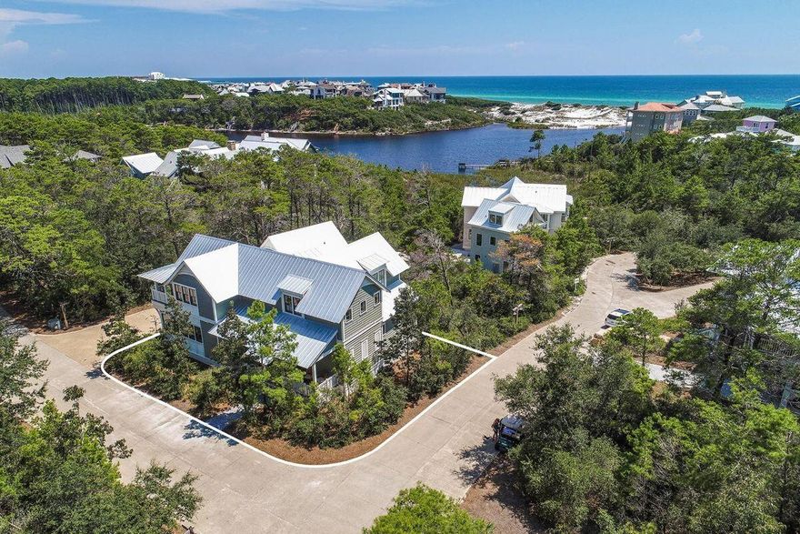 This delightful home and accompanying carriage house sit on a picturesque corner lot in the rental-restricted community of Draper Lake Coastal Village. The Village is located on the highly desirable south side of scenic Highway 30A. The house has three large porches; two of the porches provide private settings with lake breezes and peek-a-boo views of the lake, white sand dunes, and the ocean. The front porch offers a perfect perch for meeting, greeting, and visiting with neighbors.  Stepping inside, the open floor plan is designed to provide a complete first-level living experience.