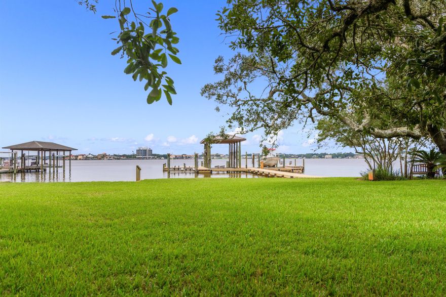 FABULOUS waterfront home on DEEP water, .55 acre lot/95' on Garnier's Bayou in the prestigious Shalimar Plantation. A vaulted foyer welcomes you with a custom ceiling & impressive stairway leading to the 2ndlevel.  As you walk into the family room, the clear sight lines running out to the bayou will delight you.  Master suite is on the 1st floor and has all the comforts of a spa.  Floor plan ensures EVERY bedroom has fantastic water views. French doors lead out to the patio & the outdoor kitchen/gazebo.  Gaze further out across the private back yard to your dock and boat lifts! Two lifts. Yes, this home has a  boat house w/a large lift and another lift configured at present for 2 jet skis.  Dock decking is the expensive perforated composite decking. The ultimate waterfront home!  WOW