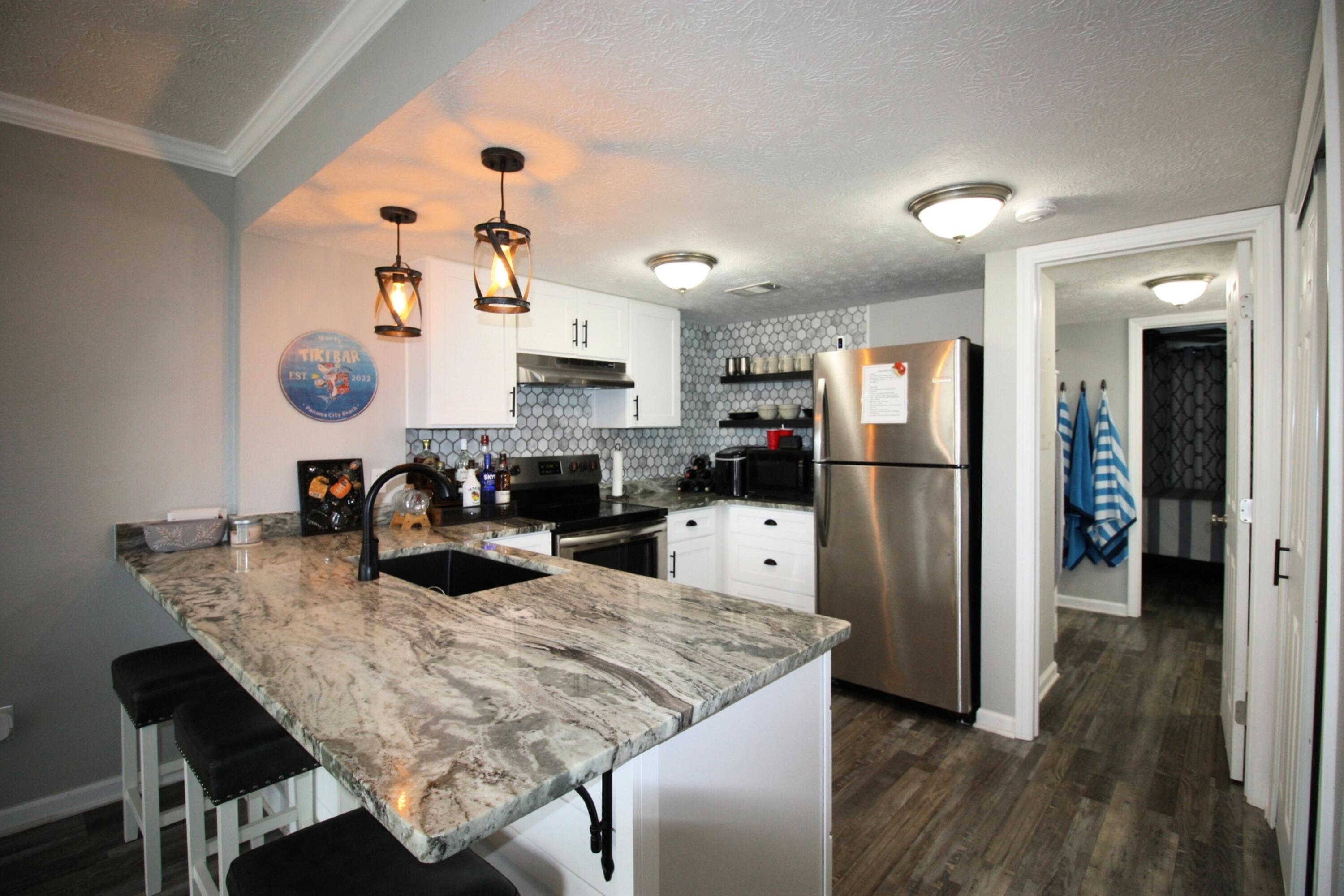 Welcome to your beachside retreat--where style, comfort, and effortless living meet, all for under $200K! This updated one-bedroom, one-bath gem is perfect as a vacation home, investment, or second residence. Located on the ground floor, it boasts a sleek open-concept kitchen with granite counters and floating shelves, flowing into a bright living space ideal for relaxing or entertaining. The spa-like bathroom features a stunning glass walk-in shower wrapped in floor-to-ceiling tile. The cozy bedroom, with double closets and coastal touches, completes this tranquil escape. Fully furnished and move-in ready, this turn-key property lets you enjoy or rent hassle-free. With the beach just minutes away, don't miss this rare opportunity--schedule your showing today!