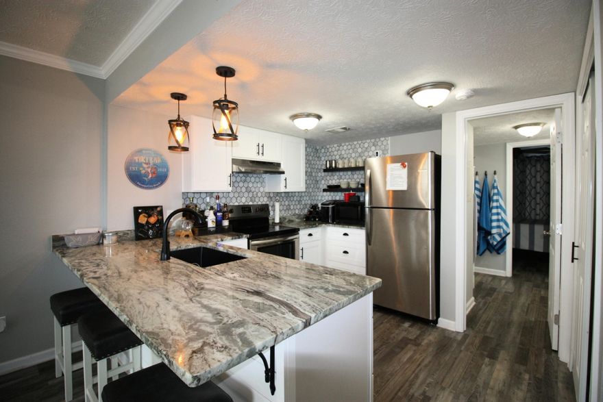 Welcome to your beachside retreat--where style, comfort, and effortless living meet, all for under $200K! This updated one-bedroom, one-bath gem is perfect as a vacation home, investment, or second residence. Located on the ground floor, it boasts a sleek open-concept kitchen with granite counters and floating shelves, flowing into a bright living space ideal for relaxing or entertaining. The spa-like bathroom features a stunning glass walk-in shower wrapped in floor-to-ceiling tile. The cozy bedroom, with double closets and coastal touches, completes this tranquil escape. Fully furnished and move-in ready, this turn-key property lets you enjoy or rent hassle-free. With the beach just minutes away, don't miss this rare opportunity--schedule your showing today!