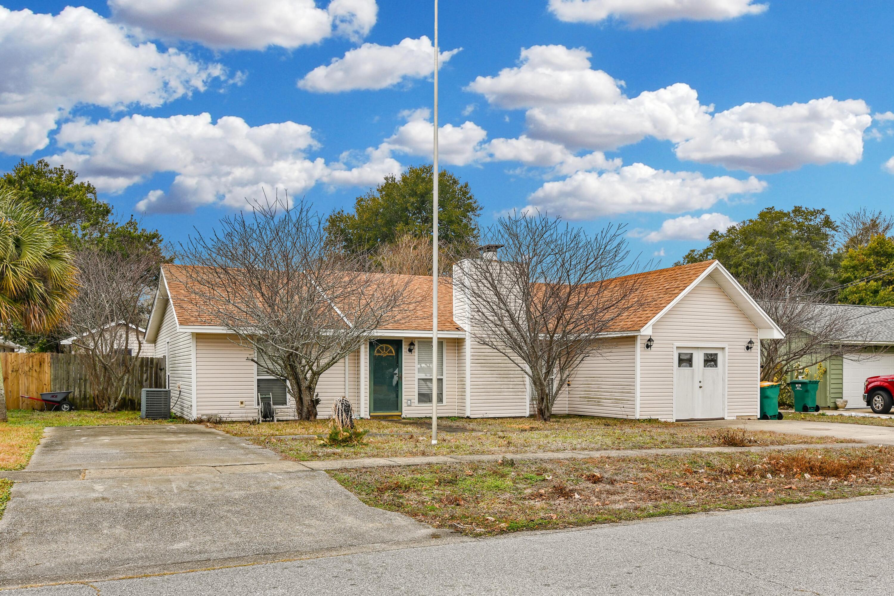 LEAST EXPENSIVE HOME IN DESTIN PRICE PER SQ FT. Great find in Destin with over 1,950 sq. ft. of living space. 3 bedroom & 2 bath with a desirable floor plan comprising of the primary suite on one side of the home & the 2 guest bedrooms & full bath on the other side of the home. Spacious living, dining & kitchen area with wood flooring in the living & guest bedrooms & tile in the kitchen & dining area. Primary bedroom is vinyl flooring with walk in closet & room for an office. Large bonus room off of kitchen area with bar sink. Two storage areas in backyard for all your yard tools and toys. *Home is in need of a new roof which at an acceptable offer price to the Seller, Seller will at Sellers expense pay for a new roof at closing from the Seller proceeds. Pre-foreclosure