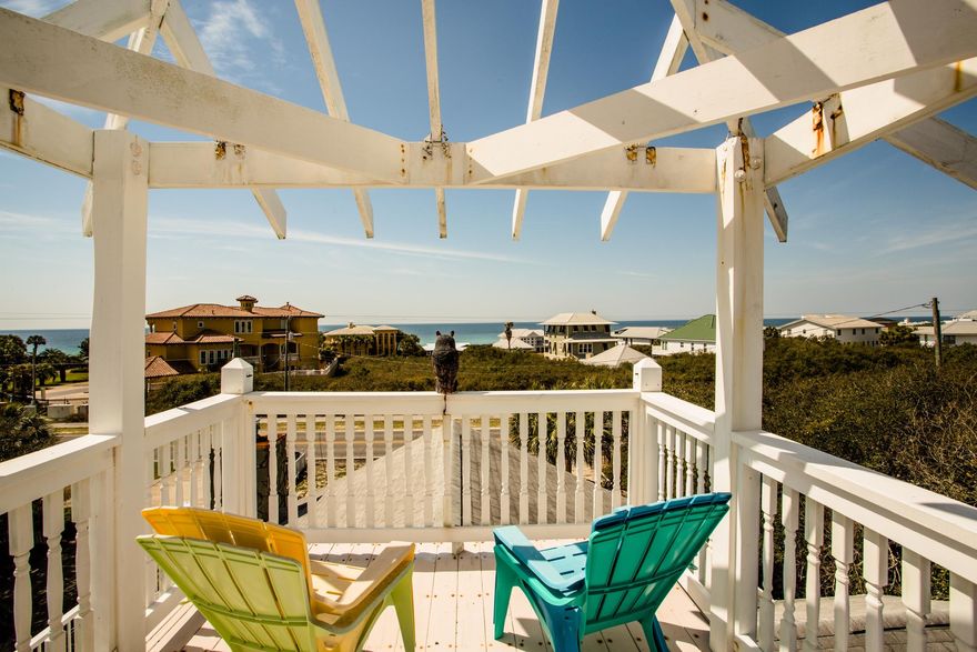 NEW PRICE!! SCENIC HWY. 30-A 'BEACH HOUSE' describes this home perfectly! EZ living is possible with a REVERSE floor plan to provide the best GULF VIEWS, & have room for the entire family to gather in the spacious GREAT ROOM. There is a FIREPLACE and open kitchen floor plan. Upstairs there are 2 large BRs, one has an en suite bath. There are 2 large BR downstairs that share a hall bath. A convenient entrance to the side yard leads to the large SCREENED POOL in the FENCED BACK YARD. A large deck off the Living Room is perfect for sunning or dining outside. A top 'perch' deck has panoramic views of the horizon. There is a 2-car garage and plenty of parking on the large lot. BEACH ACCESS is a short walk right across the street. No HOA. New carpet in BRs down & new bamboo in BRs upstairs