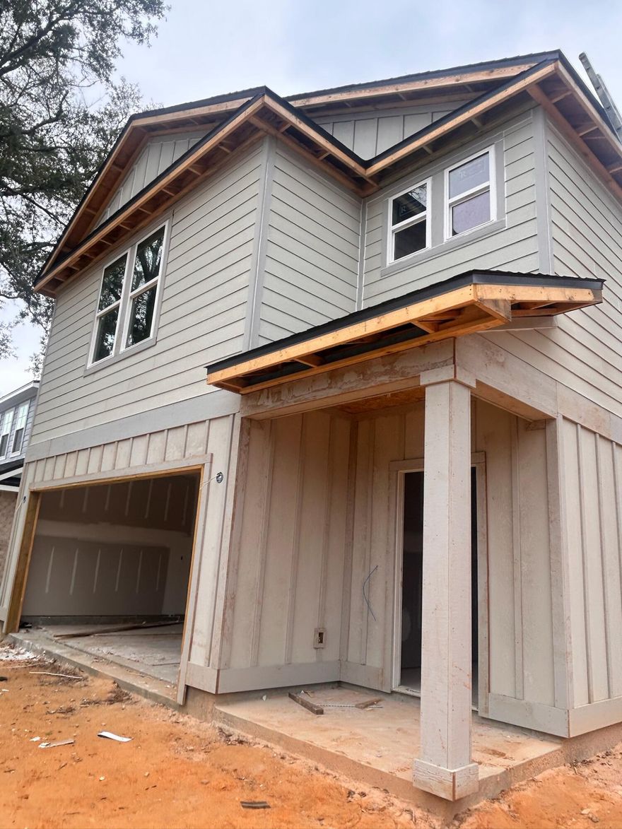 This thoughtfully designed two-story home makes a striking first impression with a coastal exterior featuring a sophisticated blend of board and batt and lap siding. A welcoming front porch leads into a functional interior, while a spacious two-car garage provides direct access to a dedicated mudroom equipped with a convenient 'drop zone' for organized daily entry.  The heart of the home is an expansive open-concept main floor that seamlessly connects the family room, dining area, and a chef-ready kitchen. The kitchen is anchored by a large island with a flat bar top and includes a walk-in pantry for ample storage. Nearby, a rear porch offers a transition to outdoor living, while a centrally located half-bath serves guests. Upstairs, the second level is designed for maximum utility and privacy, featuring four well-proportioned bedrooms. The primary owner's suite serves as a true retreat, offering an oversized walk-in closet and an en-suite bathroom with a double vanity and dedicated linen storage. Three additional bedrooms share access to two full bathrooms, and the entire floor benefits from a second-story laundry room, making household chores more efficient. ***SPRING BREAK INCENTIVES!!!***Builder incentives only available with acceptable offer. Home could be completed by March 31.