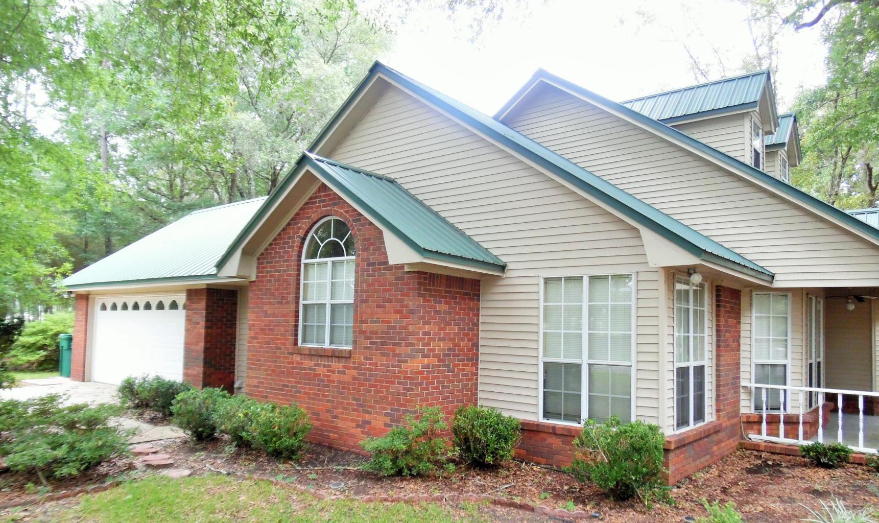 BEAUTIFUL 3bed/2bath, 2 story with BONUS LOFT area. 34 x 15 sf Florida Room with knotted pine ceiling and Hot Tub, bedrooms & baths downstairs. VERY OPEN Living Space, Kitchen with Breakfast area and separate Formal Dining room, laundry room and dbl garage are located on 1st floor. Hardwood floors with large Tiles in Florida room and Bathrooms. Metal roof, Brick fire place, bay windows, separate shower and garden tub in master bath ARE JUST SOME OF THE CHARMING FEATURES THIS HOME PROVIDES. Oversized Corner lot with Fenced in back yard and large Shady Oak trees. Well manicured yard and cared for home. NEW CEILING FANS W/ LIGHTS IN BEDROOMS, NEW MOTION CENSOR LIGHT AT ENTRANCE, NEW SKYLIGHTS, NEW PAINT MOST ROOMS, AND NEW LIGHT FIXTURES. THIS IS A GREAT LOCATION!!! VERY SOUTH 0F I-10.