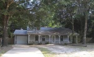 Refreshed and renewed! This lovely wood-sided home with charming stone accents has been freshly painted inside with a modern color scheme to match any decor. New carpets have been installed throughout the home and a new range, range hood, and dishwasher are also ready for use. Large shade trees dot this level lot and provide plenty of shade in the summer. The covered front porch runs nearly the entire length of the house and there is a covered deck out back overlooking the fenced backyard. The living room has high vaulted ceilings and a dramatic stone fireplace. The galley-style kitchen offers lots of cabinet space and a breakfast bar facing the open dining area. The bathrooms and kitchen are tiled. Convenient location just off Old Bethel Road. Come take a look today!