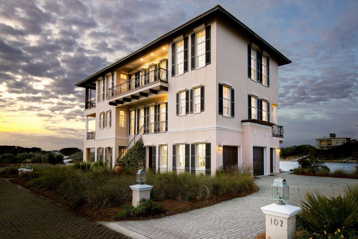 Panoramic views and a waterfront lifestyle adjoin to provide a unique ownership experience at 102 Stallworth Boulevard. This Italianate inspired lakefront home boasts a reverse floor plan with elevator for pure enjoyment of the natural surroundings as well as four master suites, each with dual vanity en-suite baths, balcony access and water views of the Gulf of Mexico to the South, and Stallworth Lake to the North. 12-foot ceilings soar throughout the second and third levels of the home while Rosewood flooring on these levels provides warmth to the crisp French Country inspired interior.