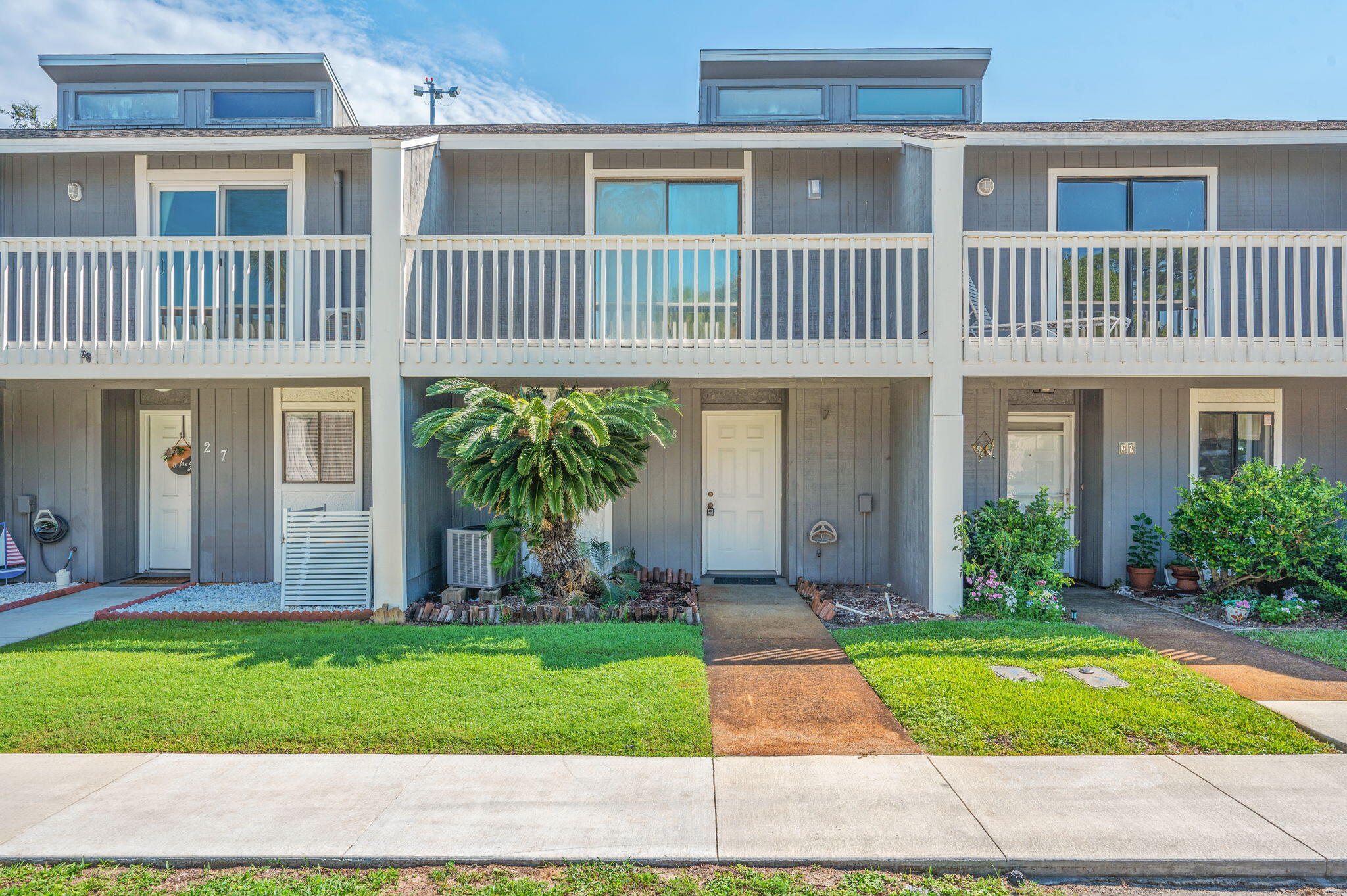 Welcome to this charming two-bedroom, two-and-a-half bath townhome with a private entrance and inviting covered front porch, located in the heart of Destin near the Executive Airport. Step inside to a bright living room featuring ceramic tile and luxury vinyl plank flooring, a stone-surround fireplace with mantel, and a sliding glass door that leads to the back patio. The kitchen is well-appointed with stainless steel appliances, a stylish tile backsplash, and windows overlooking both the living area and the exterior for plenty of natural light. A half bath downstairs includes a stone countertop vanity, making it perfect for guests. Upstairs, the carpeted bedrooms are generously sized, each with its own private bathroom. One full bath offers a stone-top vanity with a tub/shower combo, while the second bath features a cultured marble walk-in shower. The washer and dryer are conveniently located upstairs. Both bedrooms also have access to a long shared balcony, ideal for enjoying the coastal breeze. Outdoor highlights include a covered back patio, a small grassy area, a storage shed, and no neighbors directly behind the home, offering extra privacy. This townhome's central location provides easy access to beaches, shopping, dining, and all that Destin has to offer.