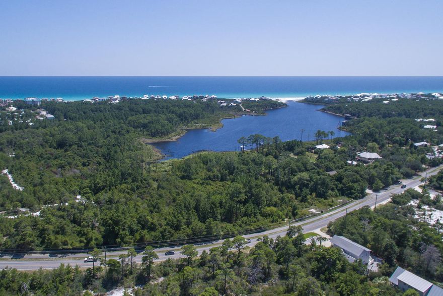 One row back from Draper Lake on the south side of Scenic Highway 30A in Blue Mountain Beach, Florida, this lot slopes down towards the lake so that views of the lake and Gulf of Mexico beyond are available. The seller of this lot has for sale two adjacent lots which can be purchased separately or in addition to this lot. Much of the lot, which is zoned as Residential Preservation, consists of a conservation easement from the Department of Environmental Protection. A retaining wall is in place on each, beautifully treed lot. Drawings of how homes could be constructed on these lots are available upon request.