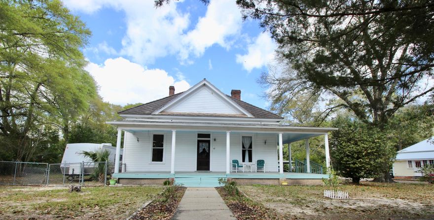 Historical diamond in the rough! This gorgeous 1925 home has 12' tall ceilings, wood floors and loads of potential! Many original features make this the perfect place to start a stunning renovation. The old fashioned wrap around porch is just waiting for someone to grab a rocking chair and glass of sweet tea! Drainboard porcelain sink in the kitchen adds extra charm. Unique original tubs in both full baths. In addition to the front living room, there's an 880sf multi-purpose room with separate entrance, which includes a separate laundry space as well. Use as an office, den, hobby room, etc. There's also a generously sized fenced in yard. Just 3 blocks to Lake DeFuniak & 30 minutes to the sugar white sands of Walton County beaches! Being sold As-Is with cash or conventional financing only.