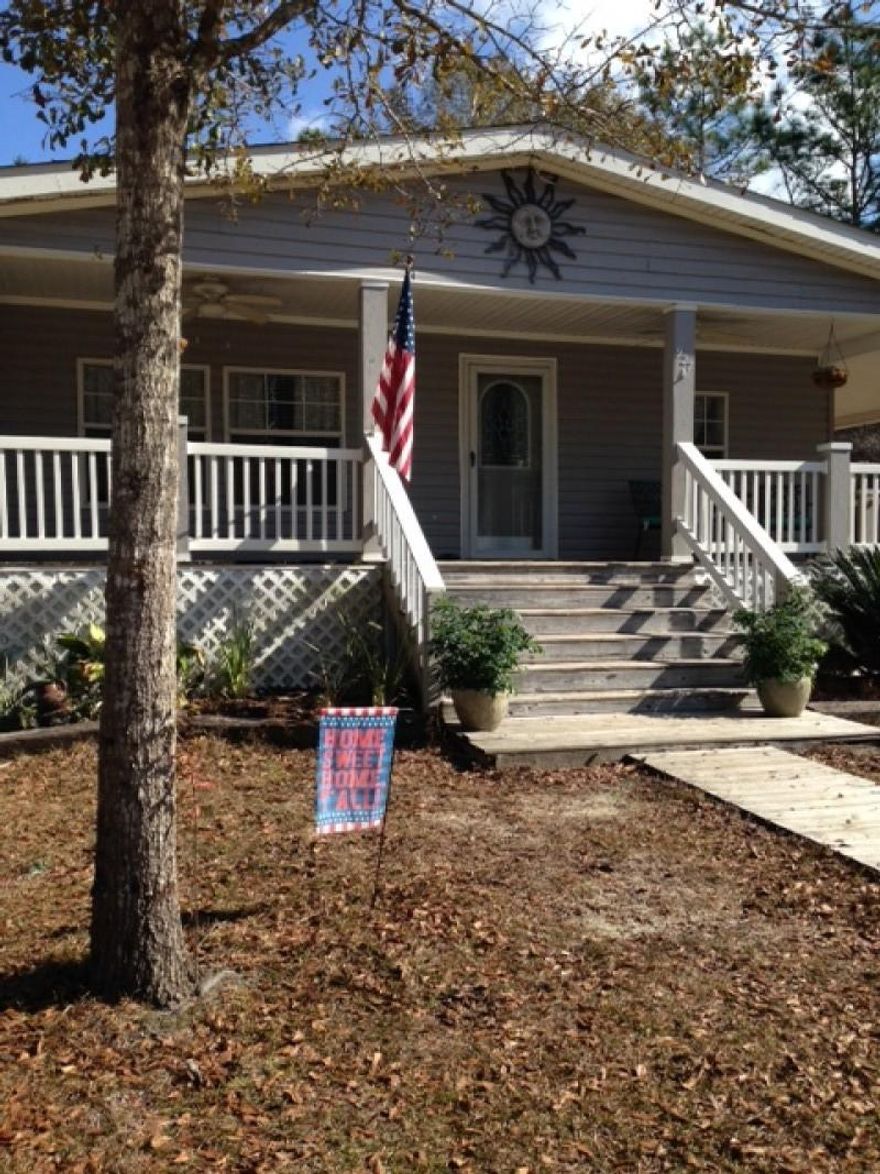 Beautiful 3 bedroom/2 bathroom located in the Black Creek area. Only 5 minutes from the new Publix and 15 minutes to the beach. Freshly painted and new carpet in bedrooms. Hard surface floors in the rest of the house. Huge wrap around covered porch. Large attached carport. Tons of storage and a great yard. Home is considered real property/permanent residence, so traditional financing is allowed.